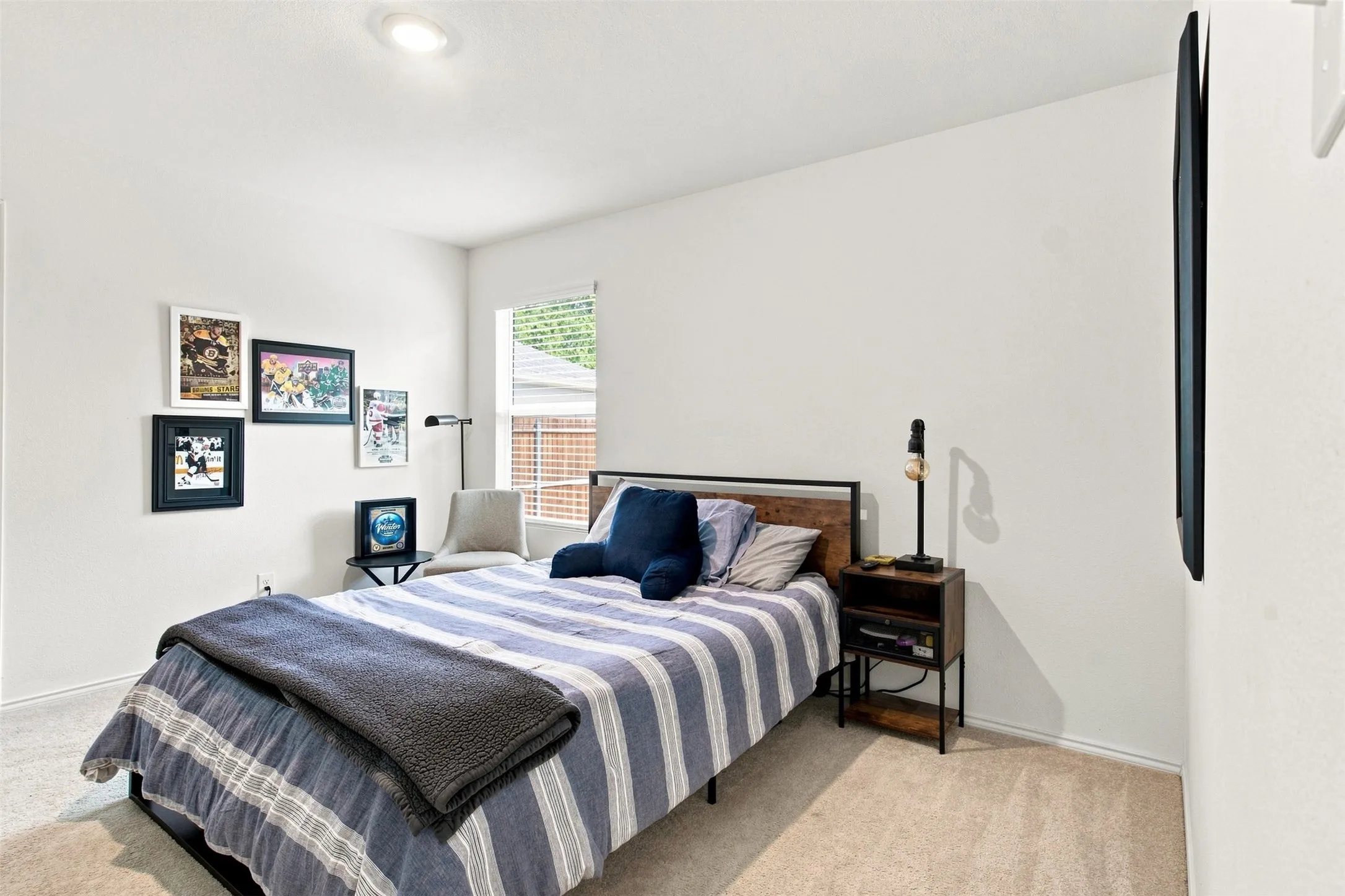 Recessed ceiling lighting, light-colored carpeting, window with blinds, white wall finishes, and a wall-mounted flat screen