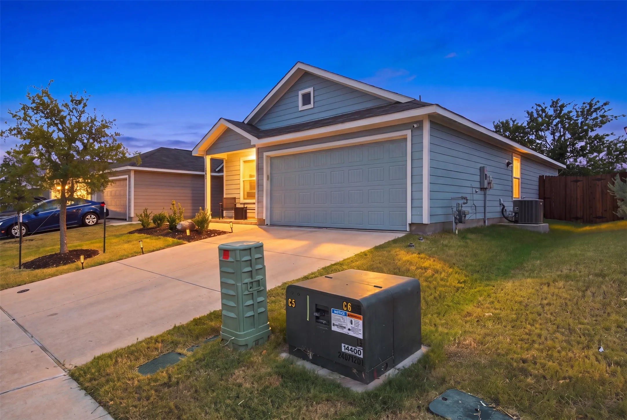 Siding exterior with a covered porch entry, attached garage, and concrete driveway