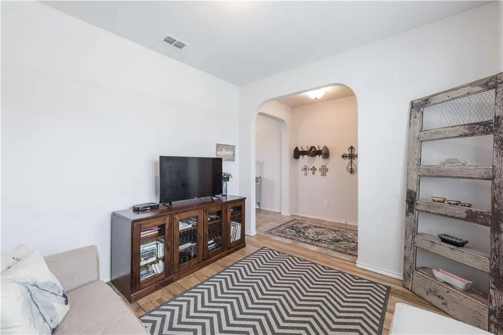 Wood-finish flooring throughout, complemented by a light neutral wall color