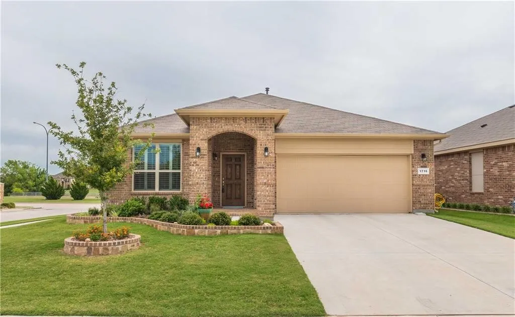 Elegant brick exterior with arched entryway and decorative stone accents