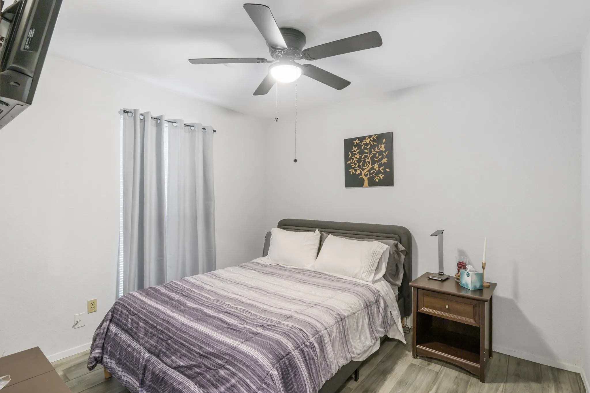 Secondary bedroom features a ceiling fan and a walk in closet