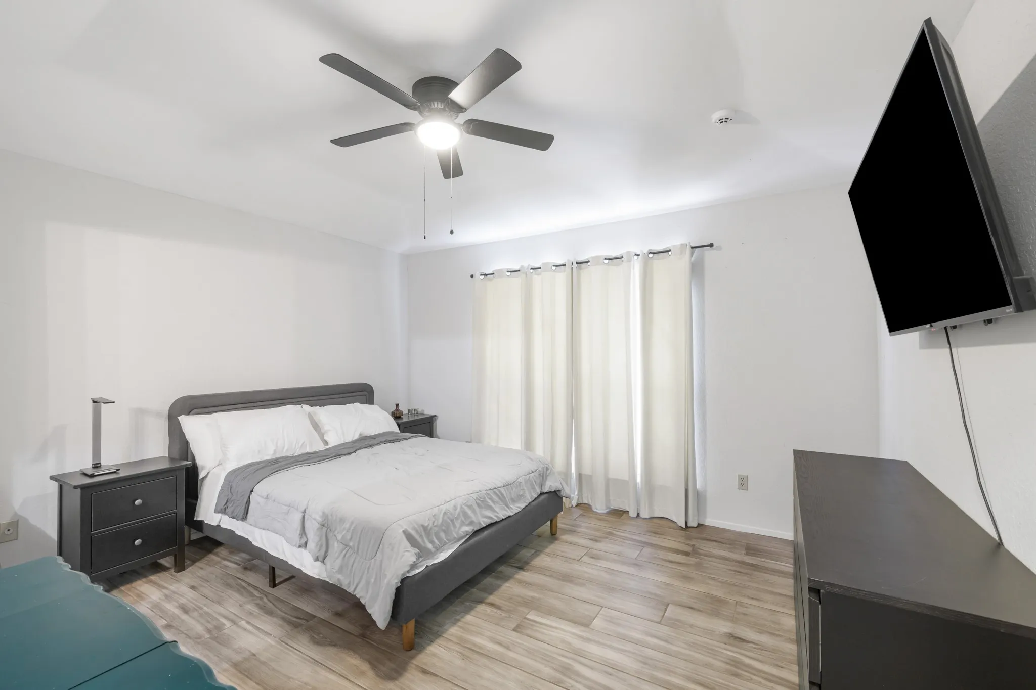 Primary bedroom features an ensuite bathroom and large window to let in natural light.