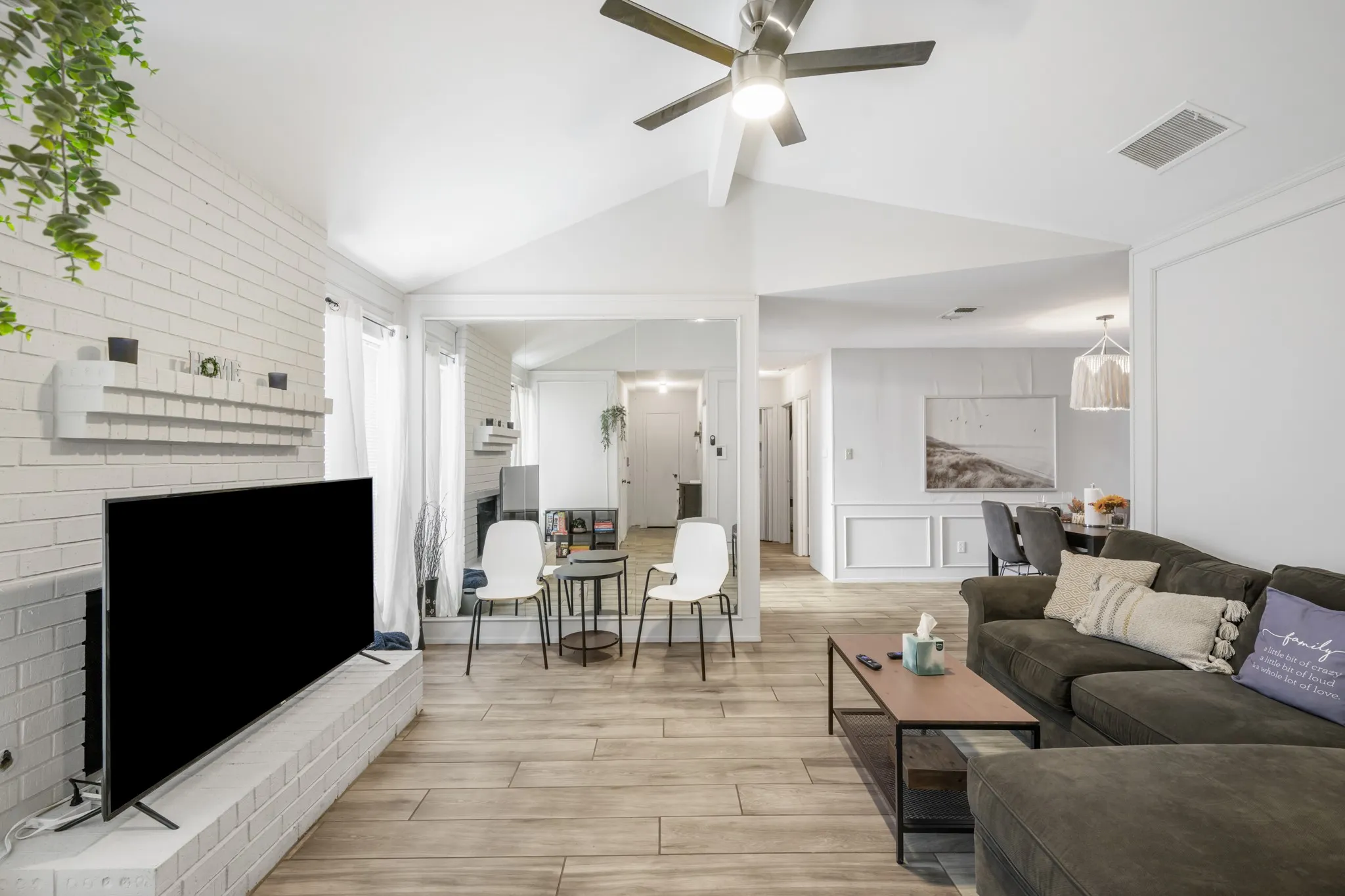 Living room features a brick fireplace
