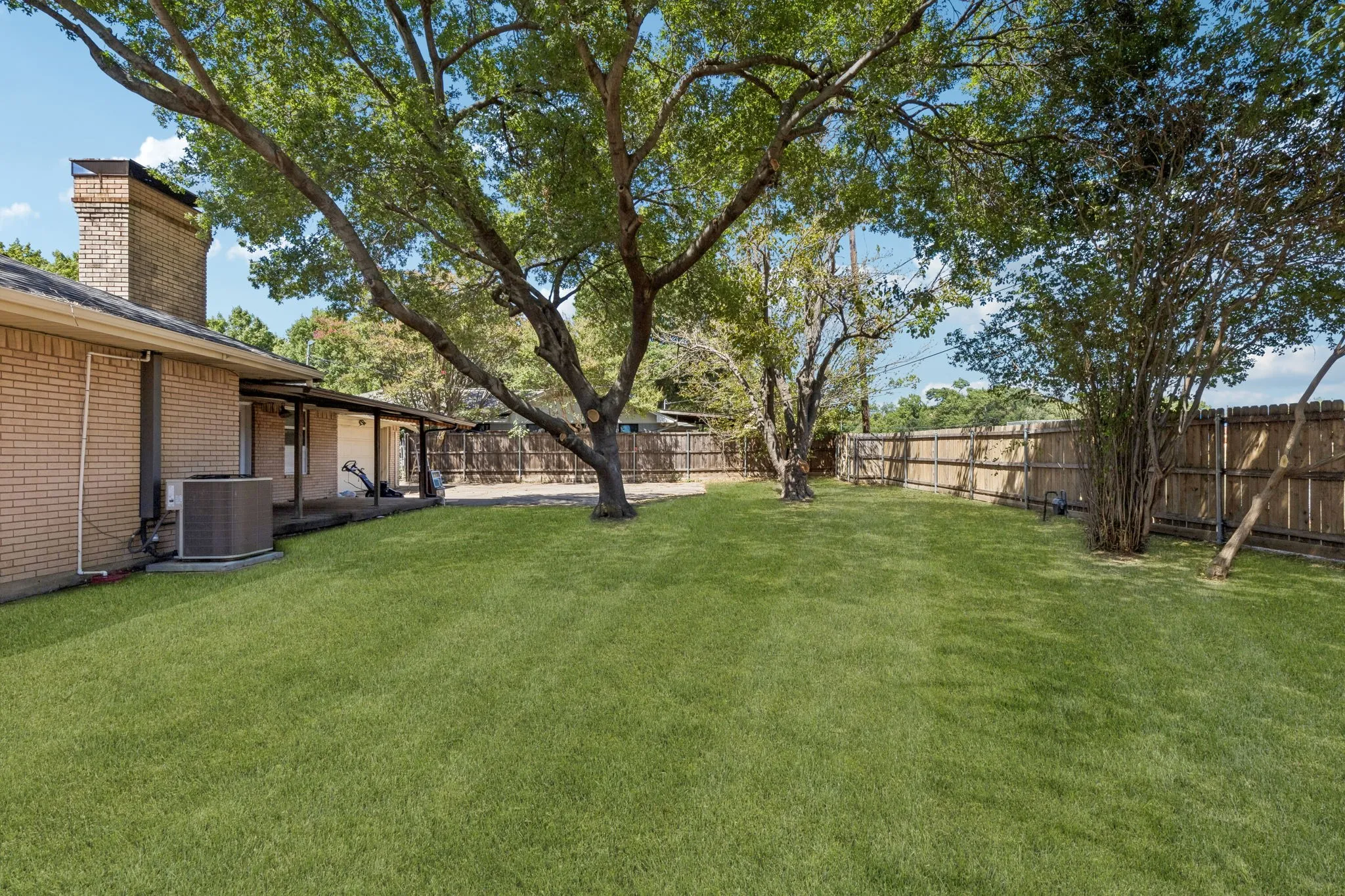 Large backyard. Photo is enhanced to show the possibility with new sod.