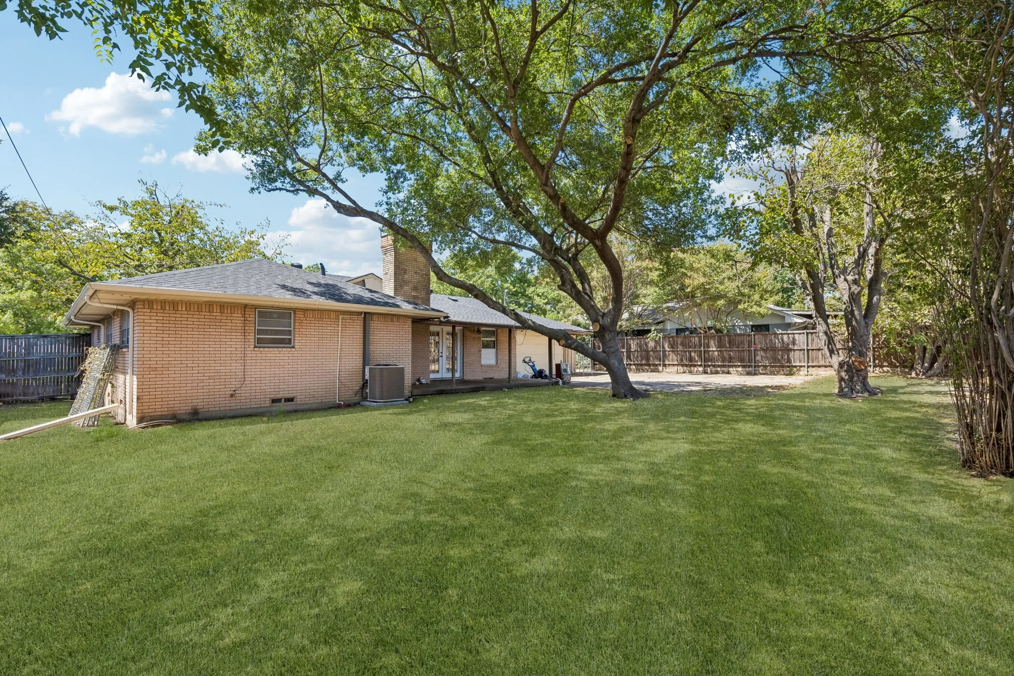 Large backyard. Photo is enhanced to show the possibility with new sod.