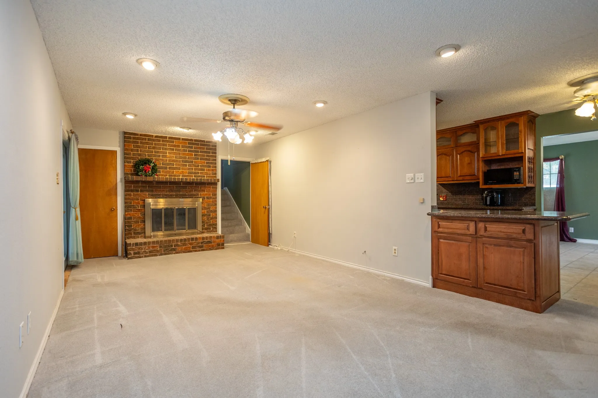 There is a serving area at the end of the kitchen