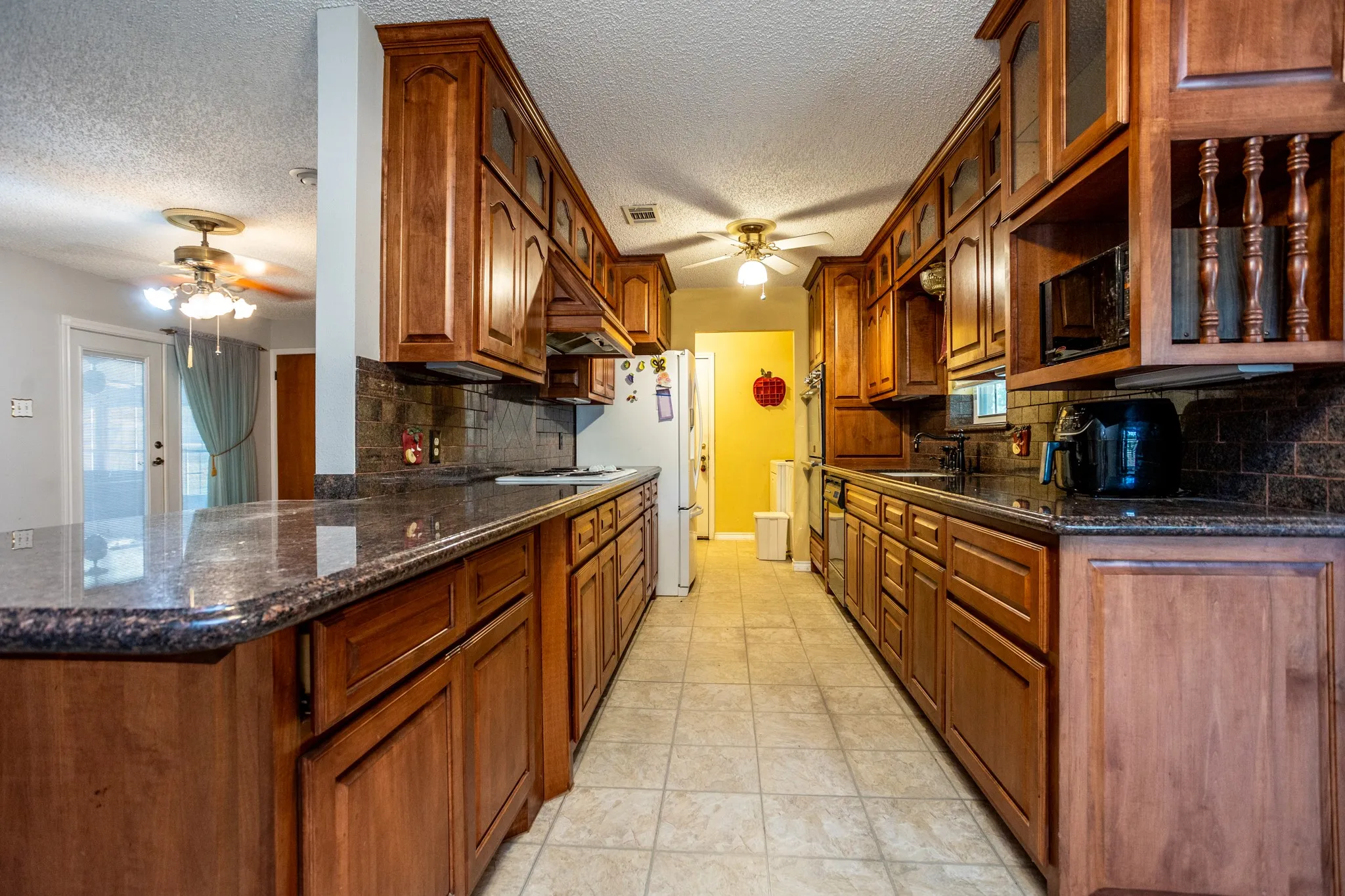 Lots of work space on granite counters. To right is space for microwave.