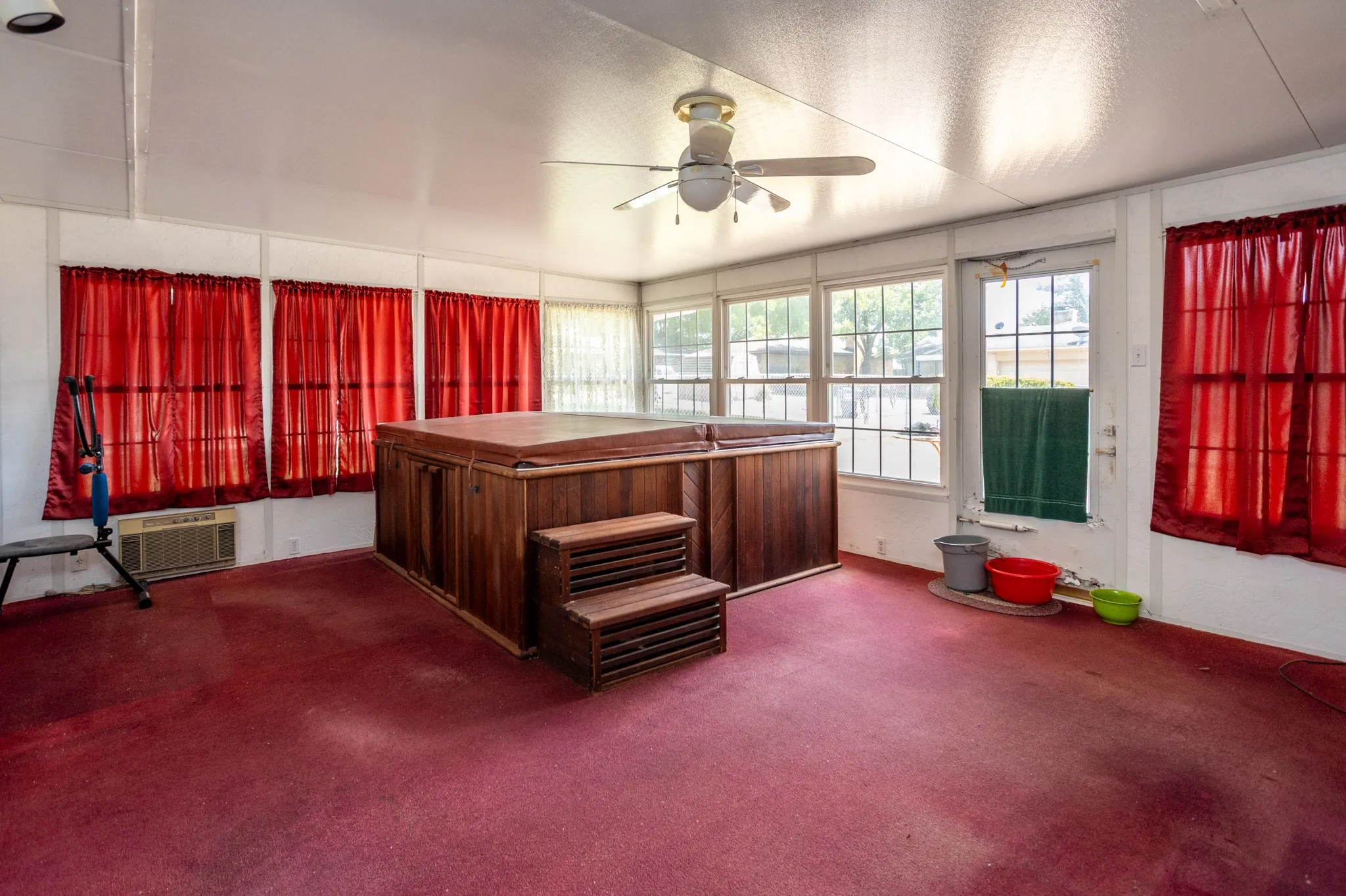 Enclosed porch features a hot tub that remains with property.
