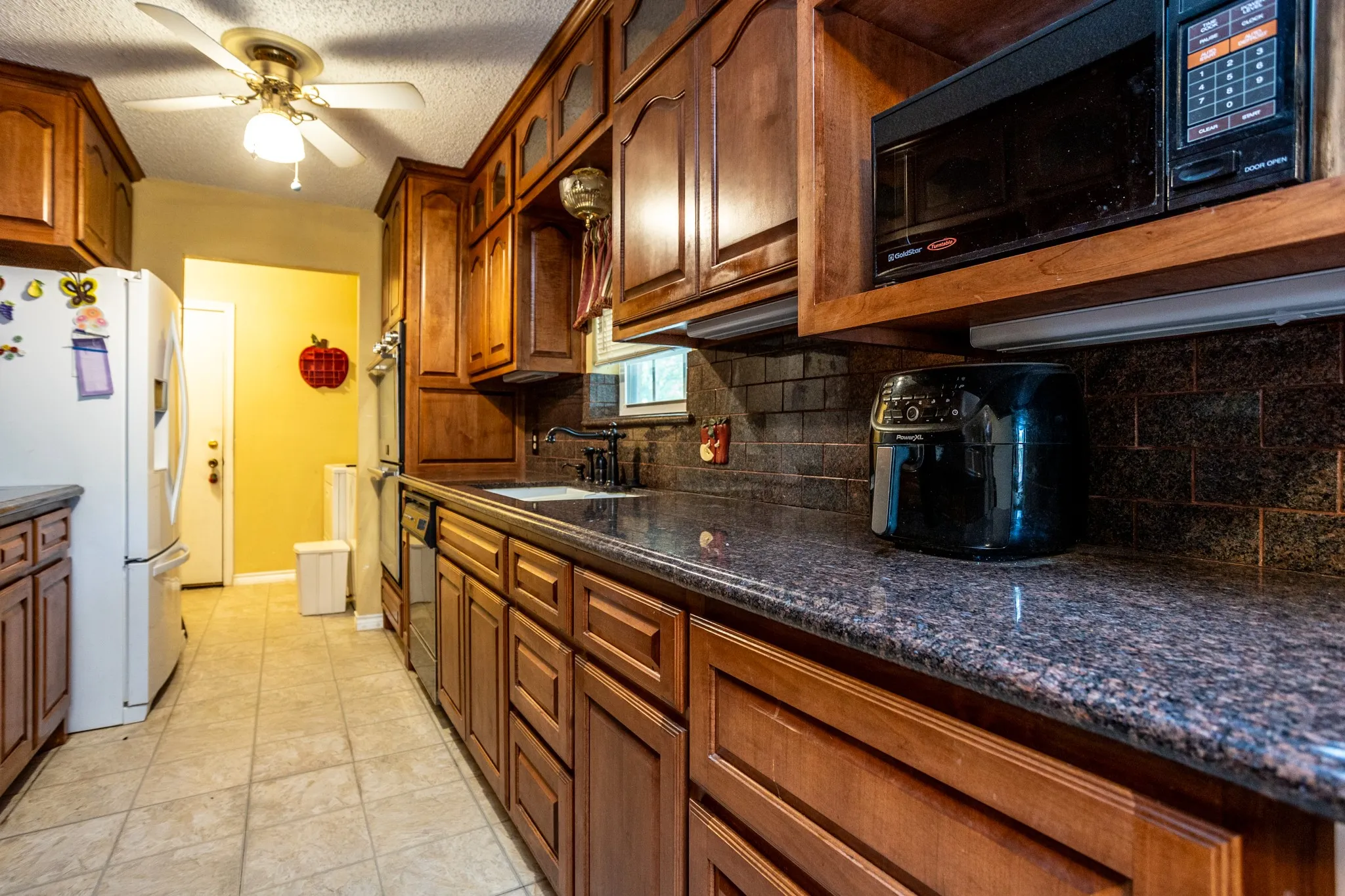 Kitchen opens to utiity room with doors going down to garage.