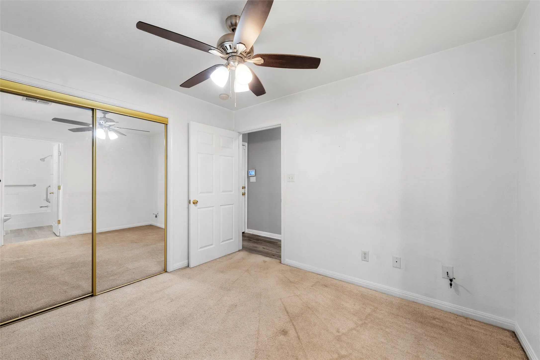Unfurnished bedroom with carpet floors, a closet, and baseboards