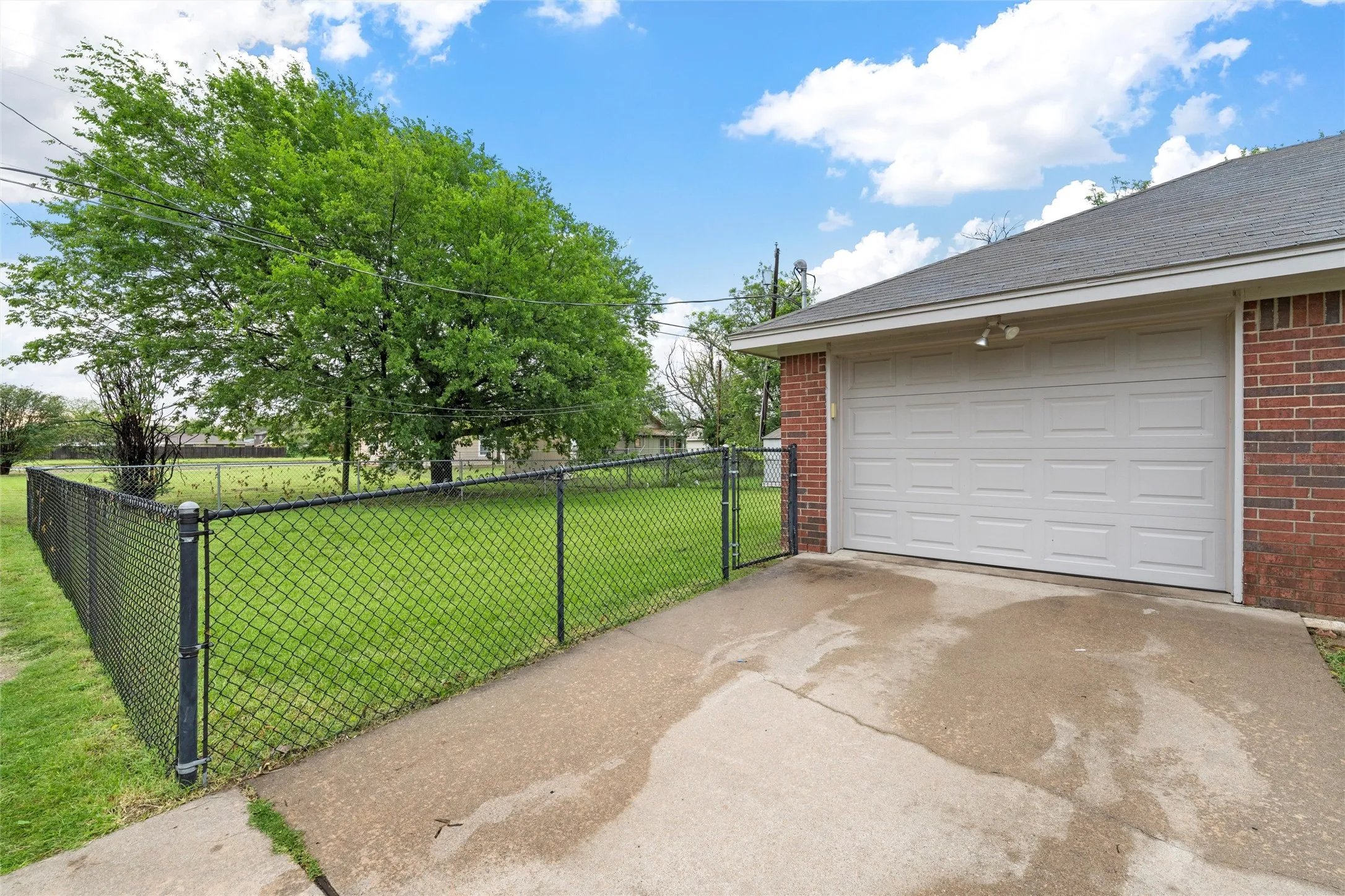 Garage with driveway and a gate