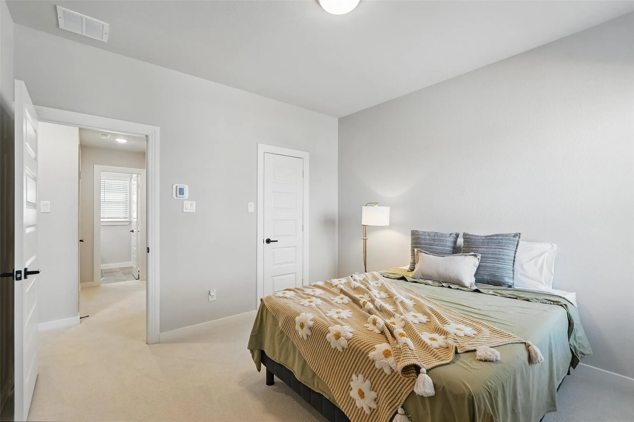 Carpeted flooring, white walls, and white trim throughout
