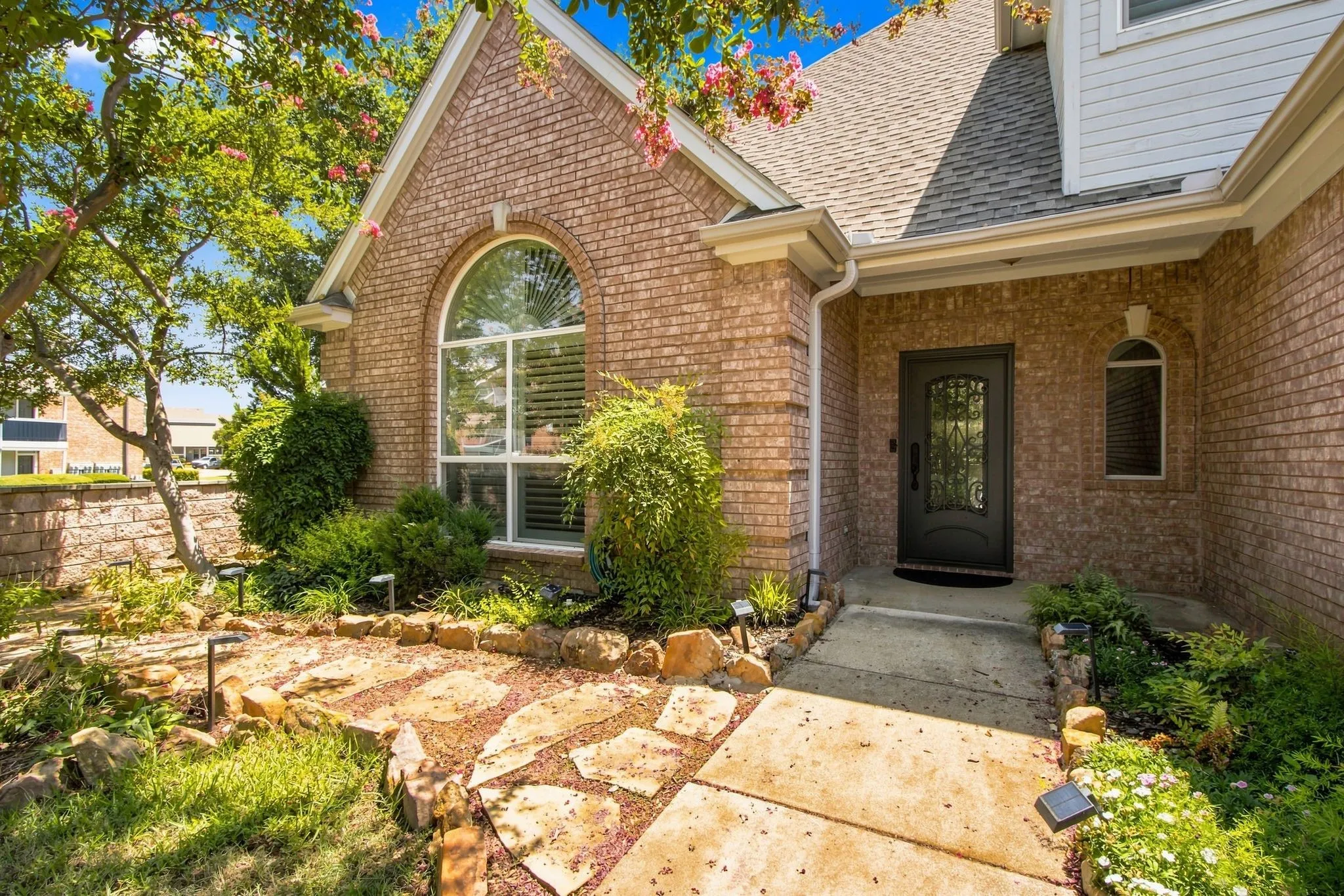 Covered porch and extensive landscaping.