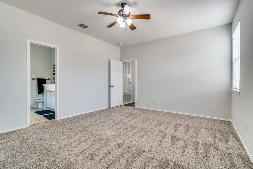 Spacious room featuring neutral carpet flooring and light-toned walls