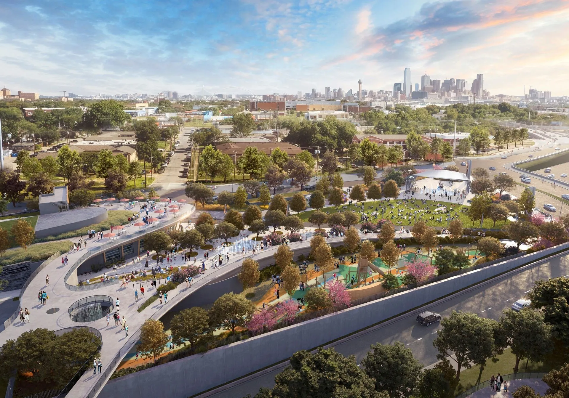 Expansive urban parkland with pedestrian pathways, mature trees, and a distant cityscape