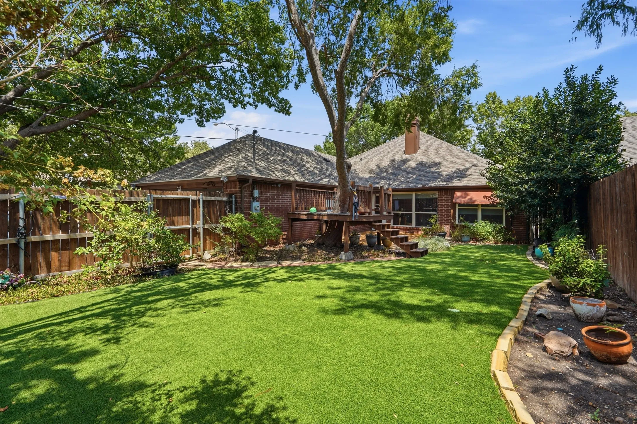 Low maintenance backyard with artificial turf.