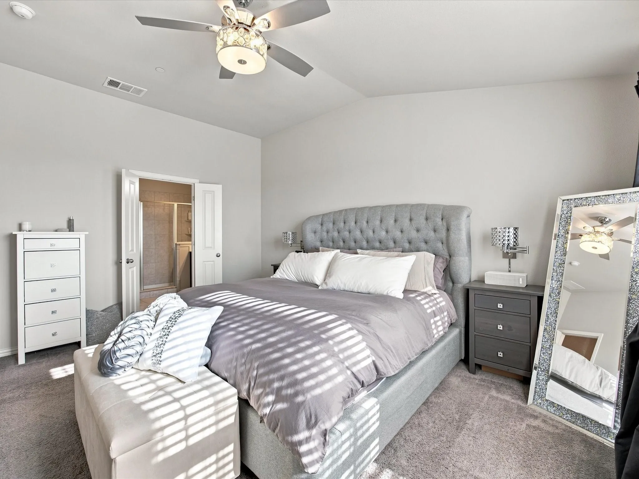 Neutral wall color throughout, ceiling fan with integrated lighting, and carpeted flooring