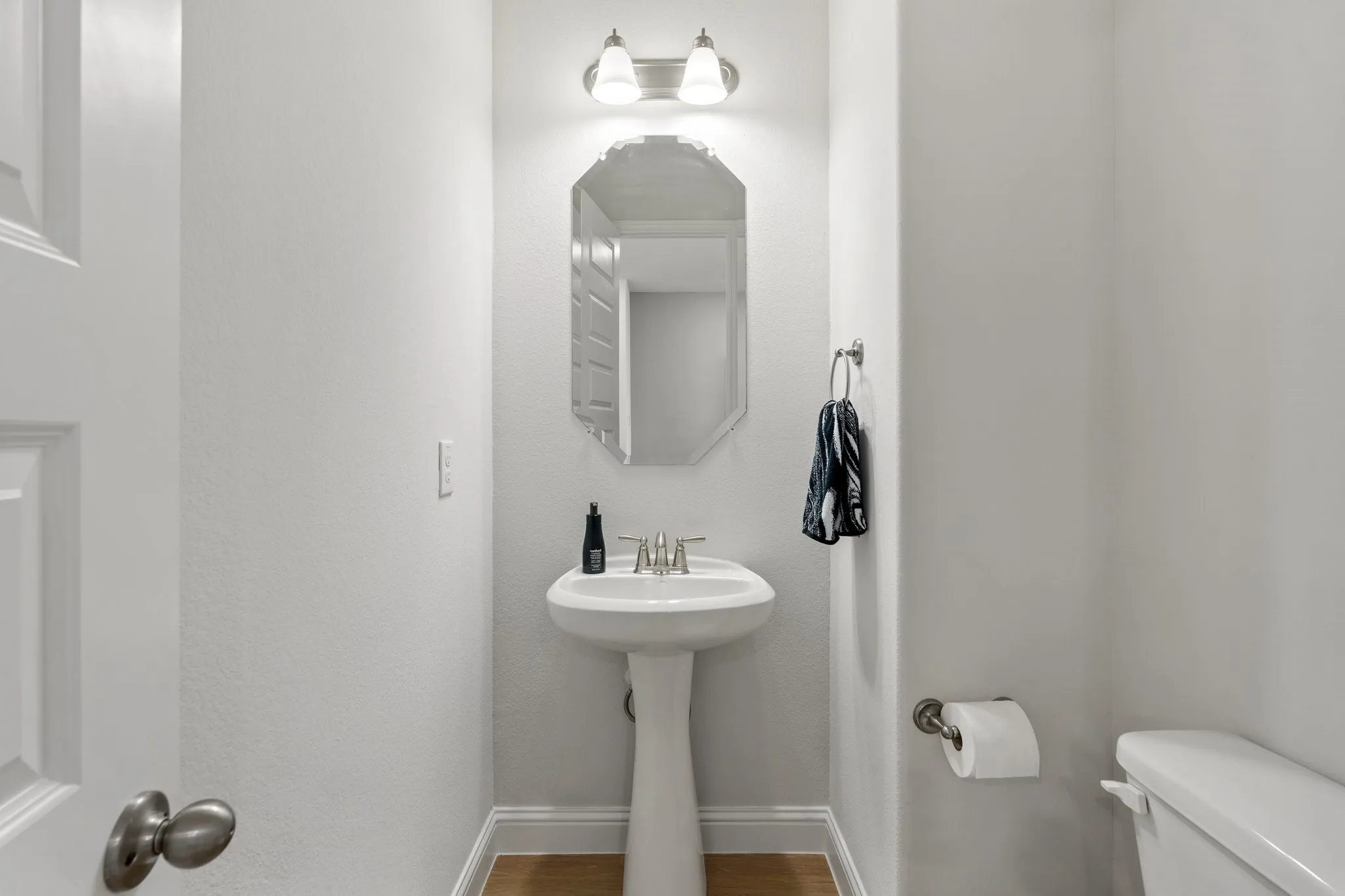 Bathroom featuring wood-type flooring and toilet