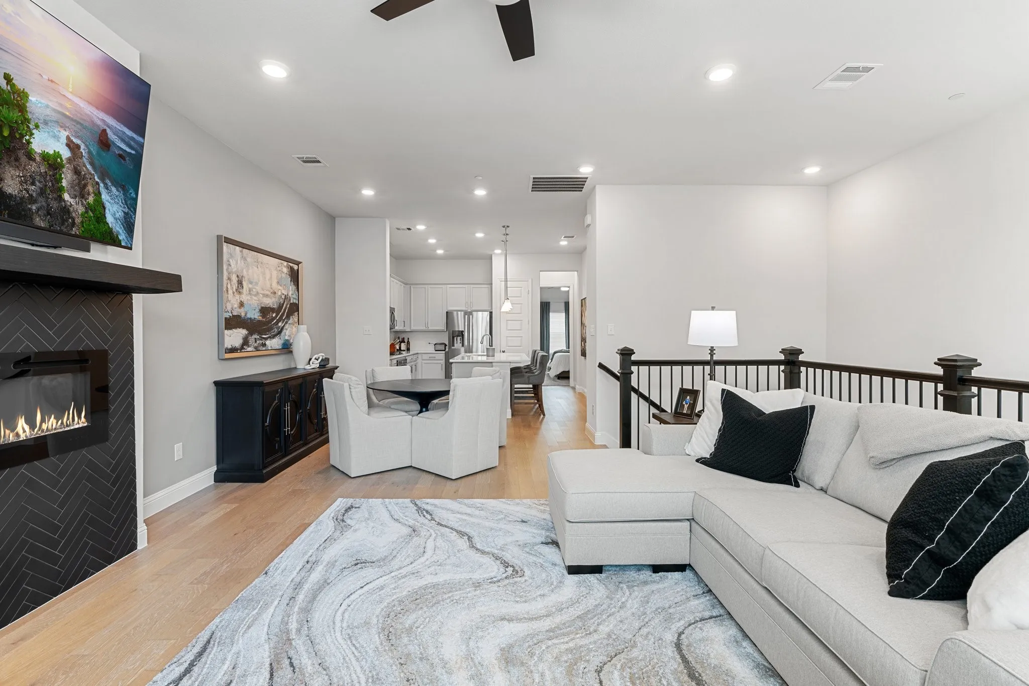 Living room with light wood-type flooring and ceiling fan