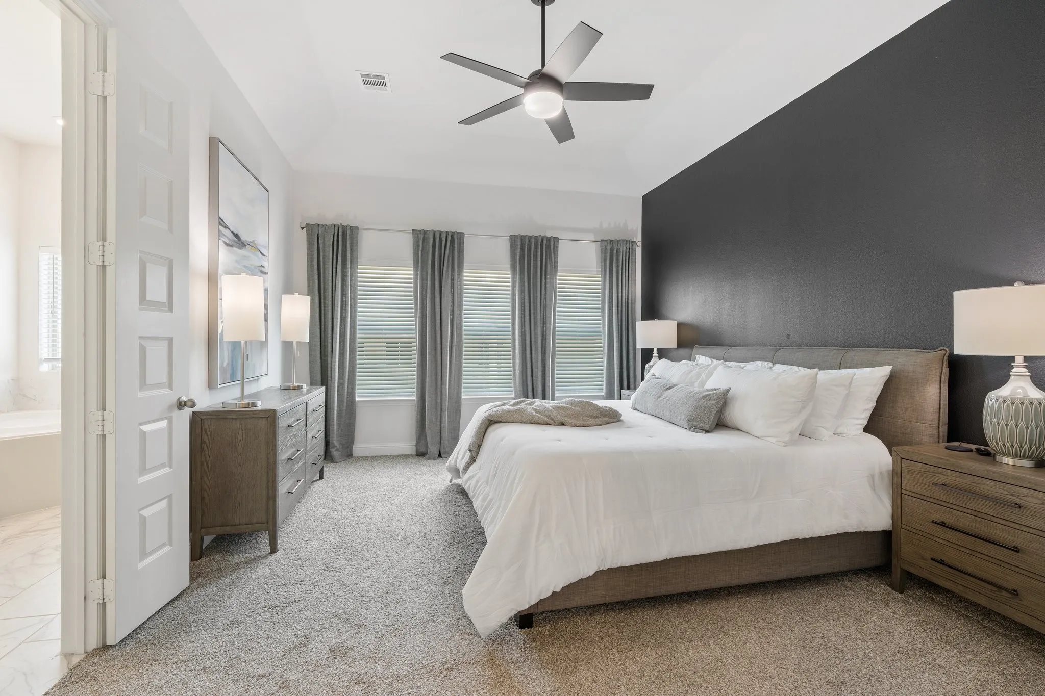 Carpeted bedroom featuring ceiling fan