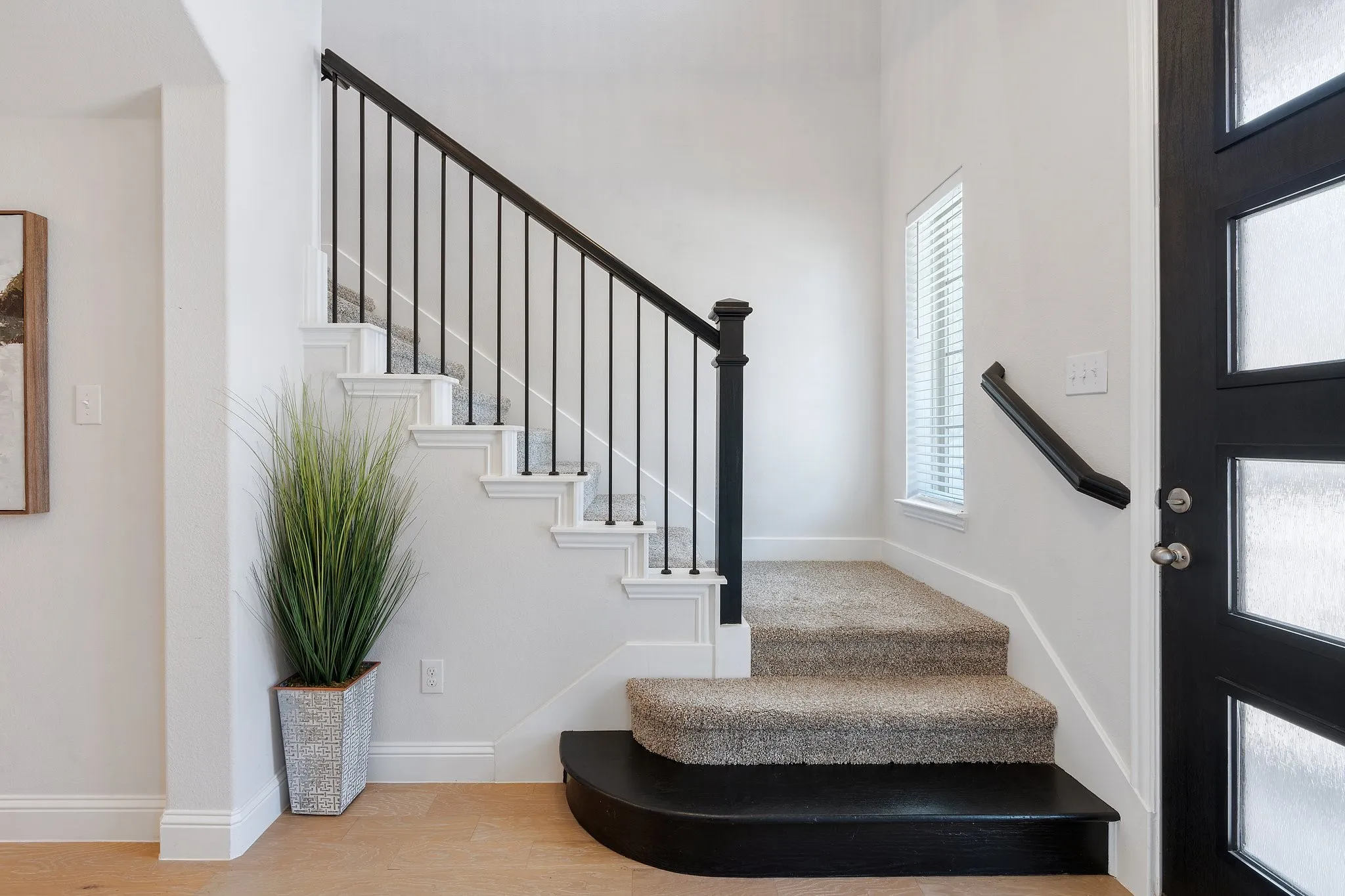 Stairs featuring wood-type flooring and a healthy amount of sunlight
