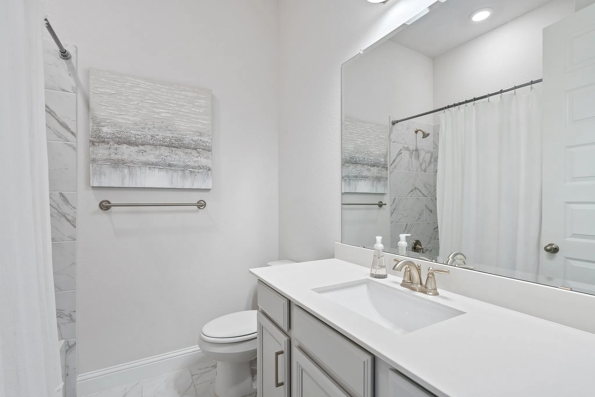 Full bathroom with vanity, toilet, tile patterned floors, and shower / bath combo with shower curtain