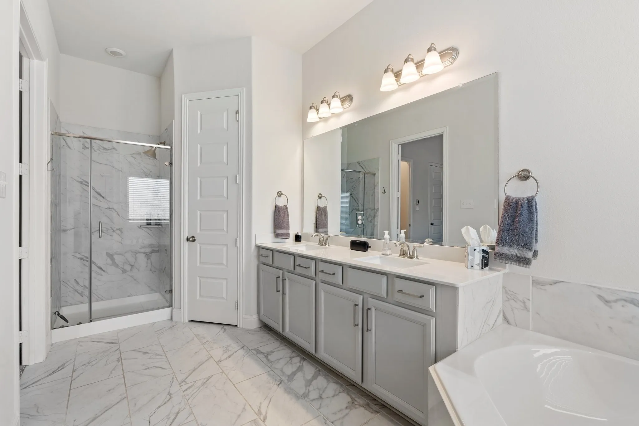 Bathroom with shower with separate bathtub, tile patterned floors, and dual bowl vanity