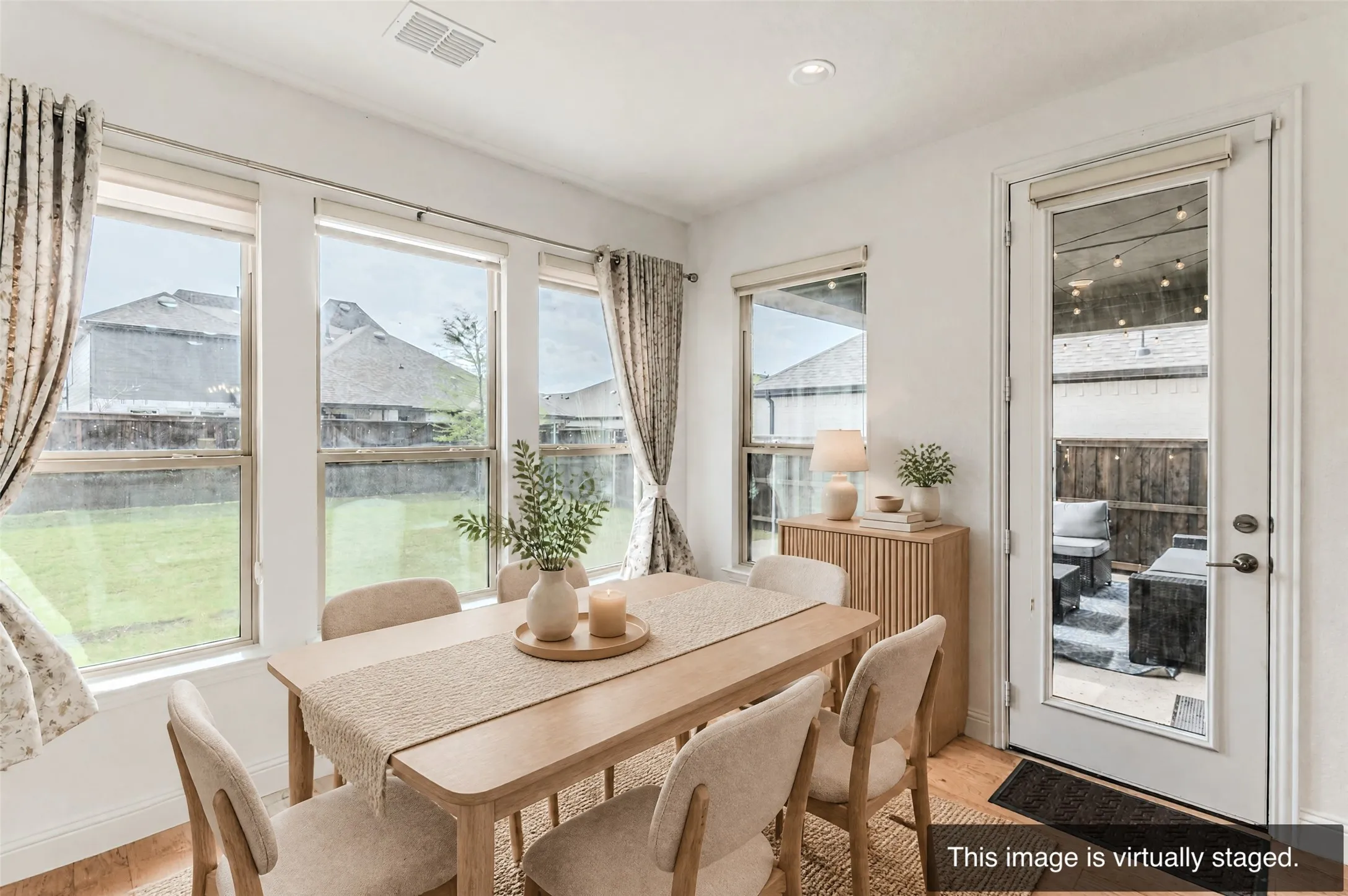 Recessed lighting, wood-finish flooring, multiple windows, full-light door, and a private outdoor patio area