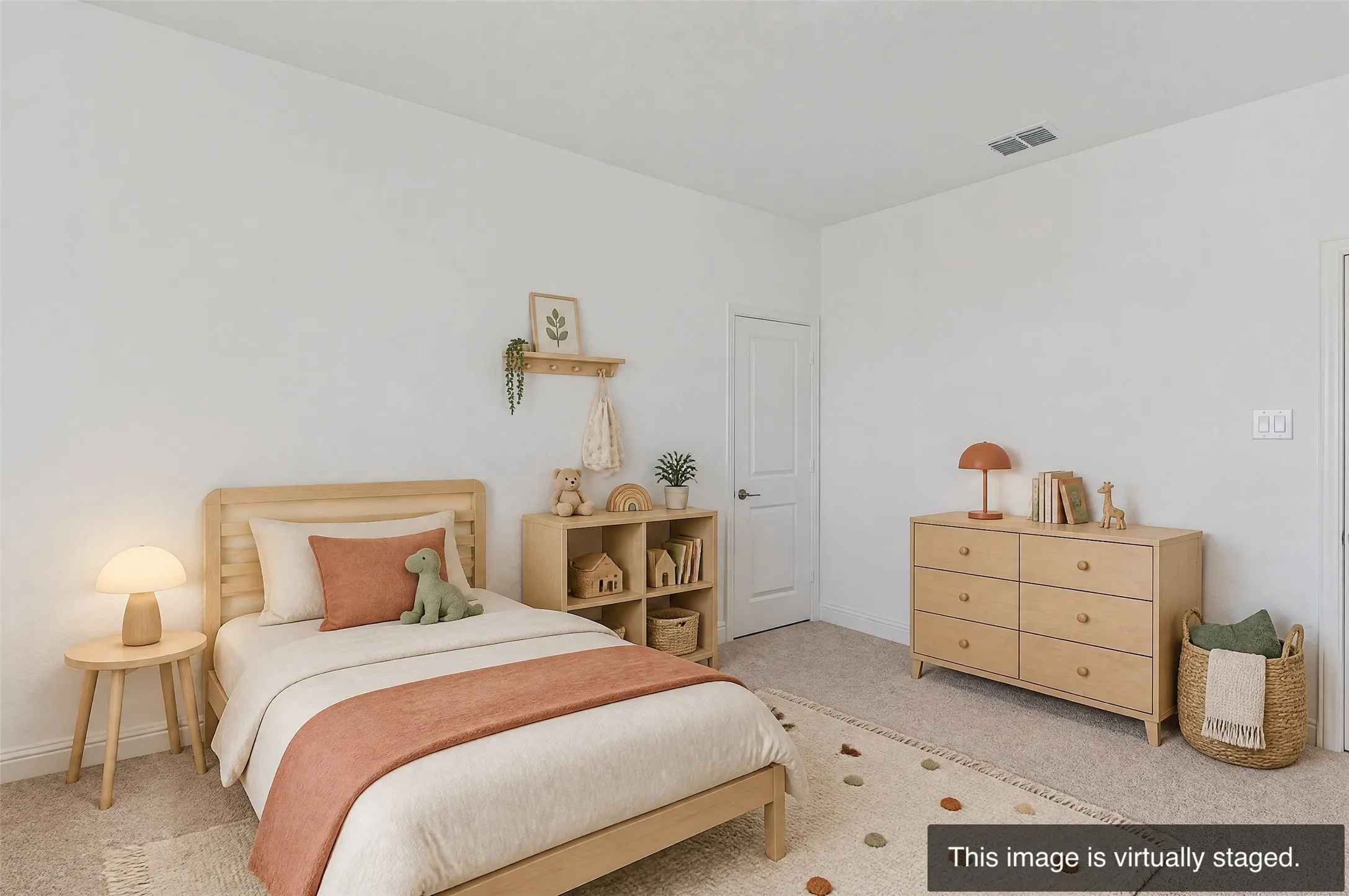 White walls, light-toned wood-finish flooring, and a white door with dark hardware