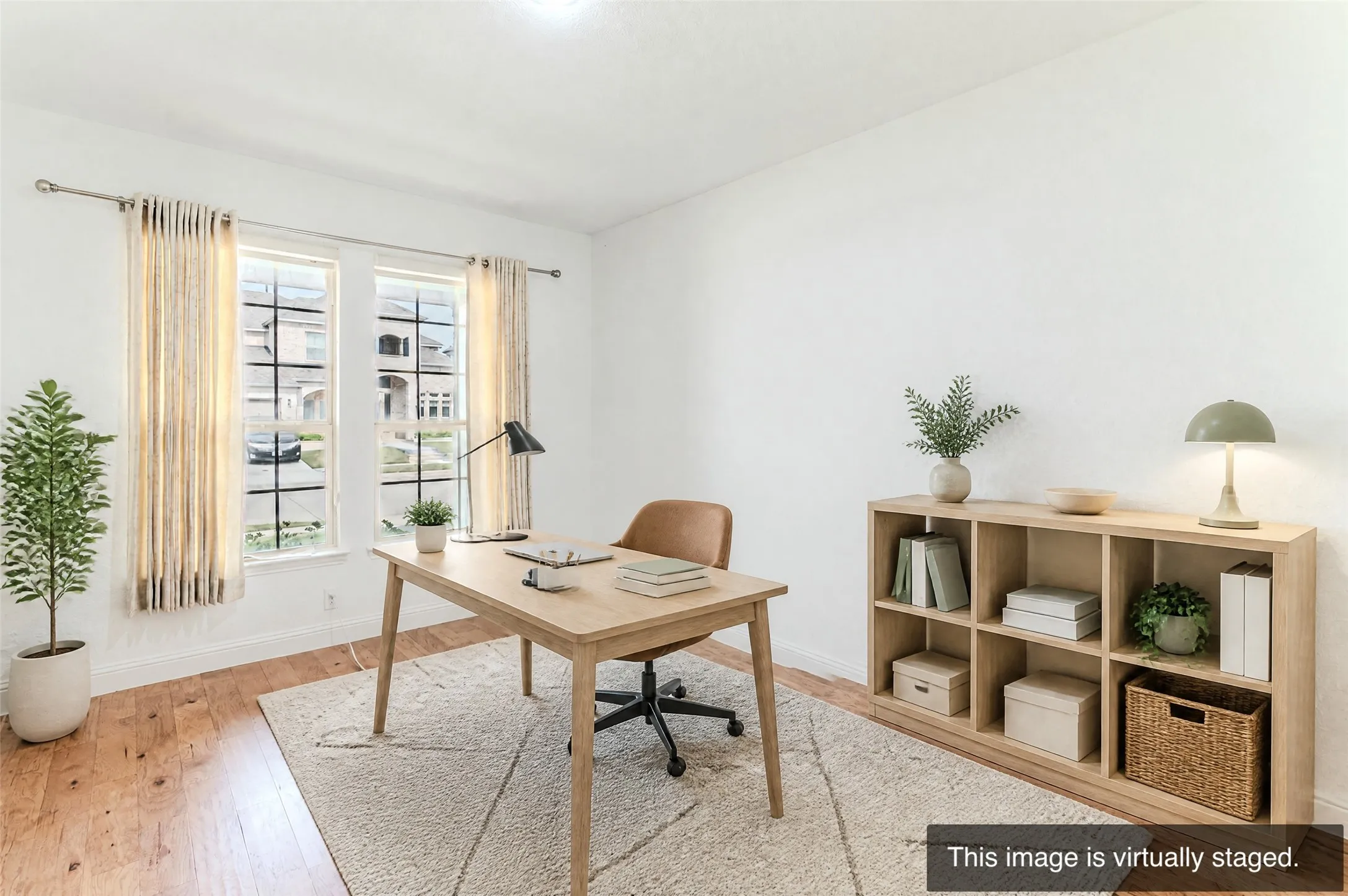 Hardwood-style flooring, white walls, and two large windows with grid accents