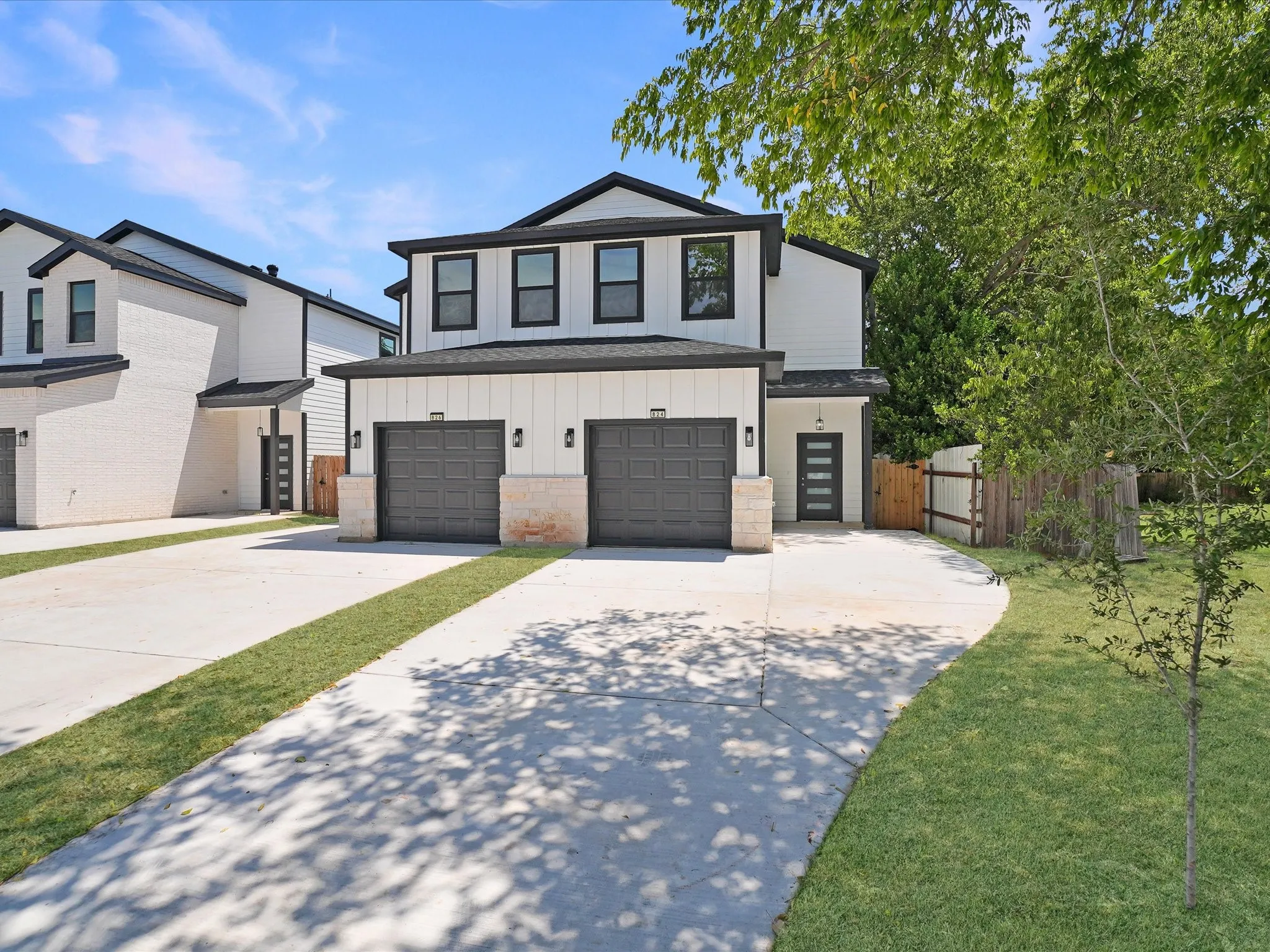 Contemporary exterior with white siding and dark trim