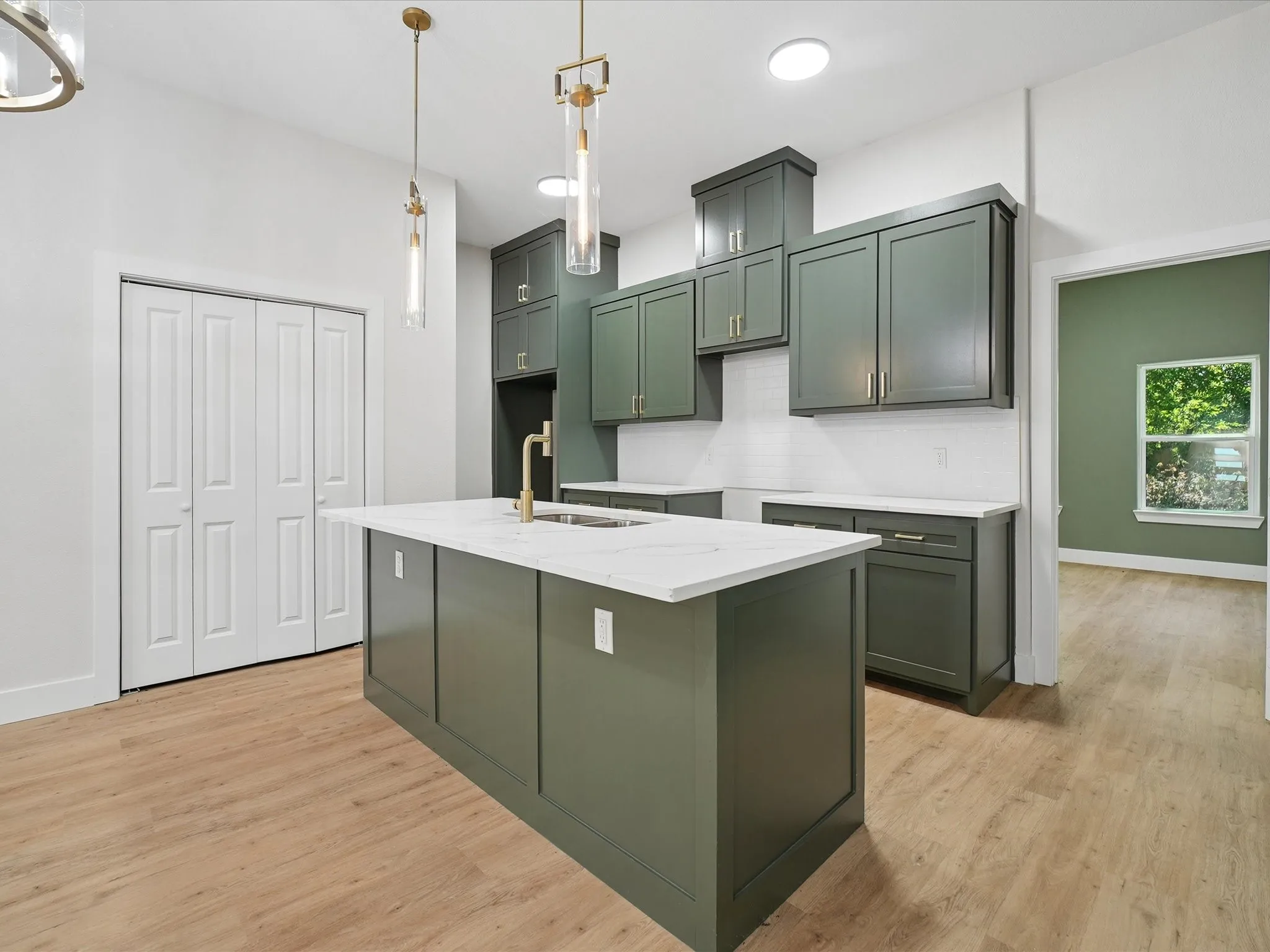 Kitchen featuring a central island with countertop, wood-finish flooring, recessed lighting, and modern pendant fixtures