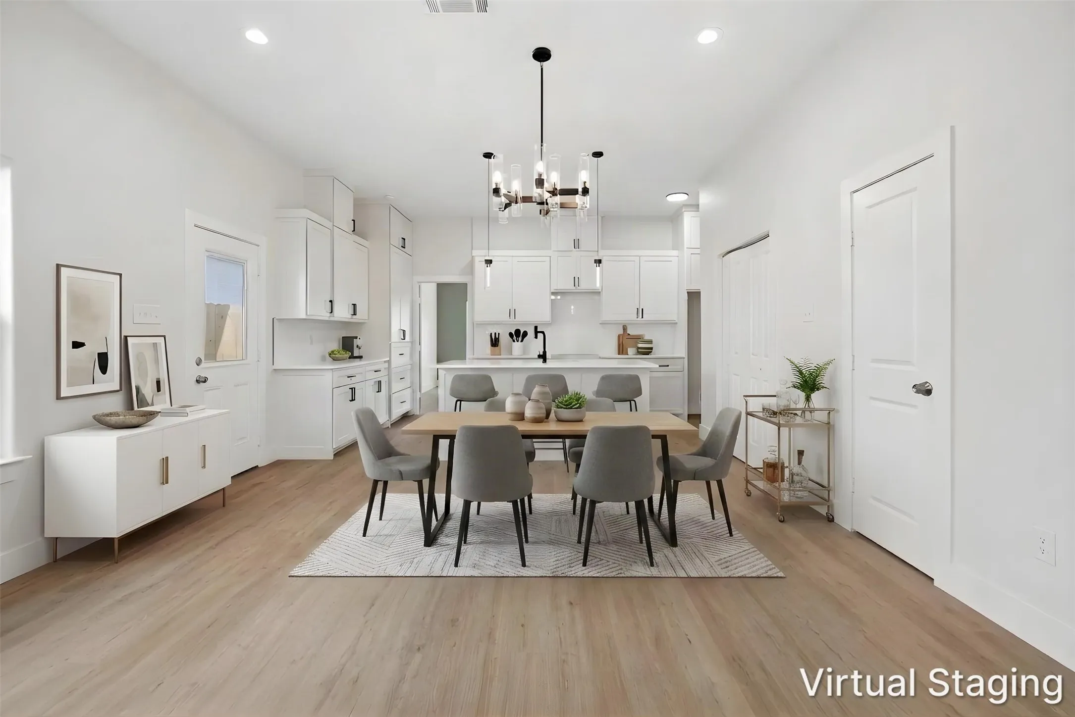 Open-concept living space with wood-finish flooring, recessed lighting, and a modern chandelier