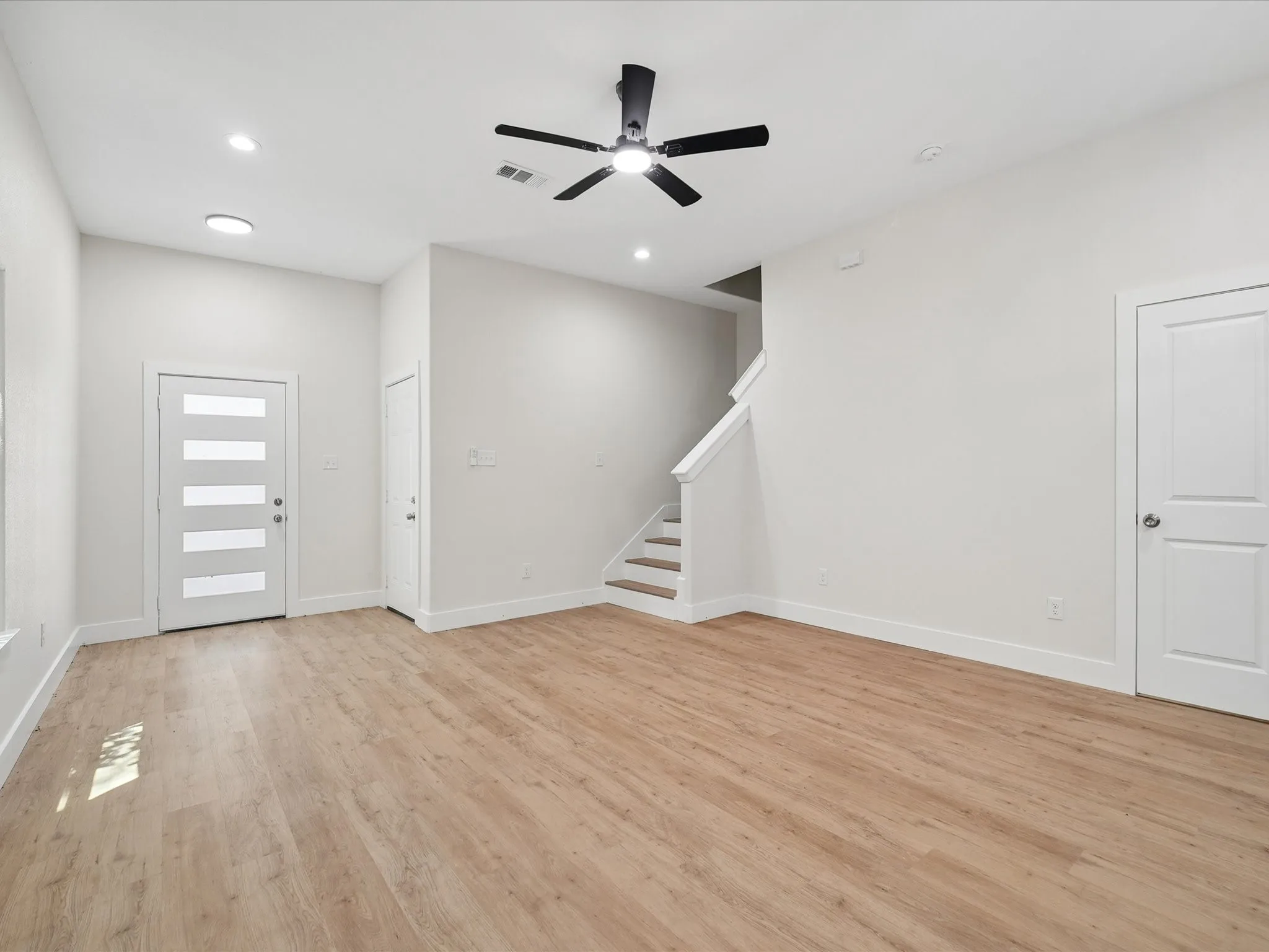 Wood-finish flooring, recessed lighting, and a modern ceiling fan