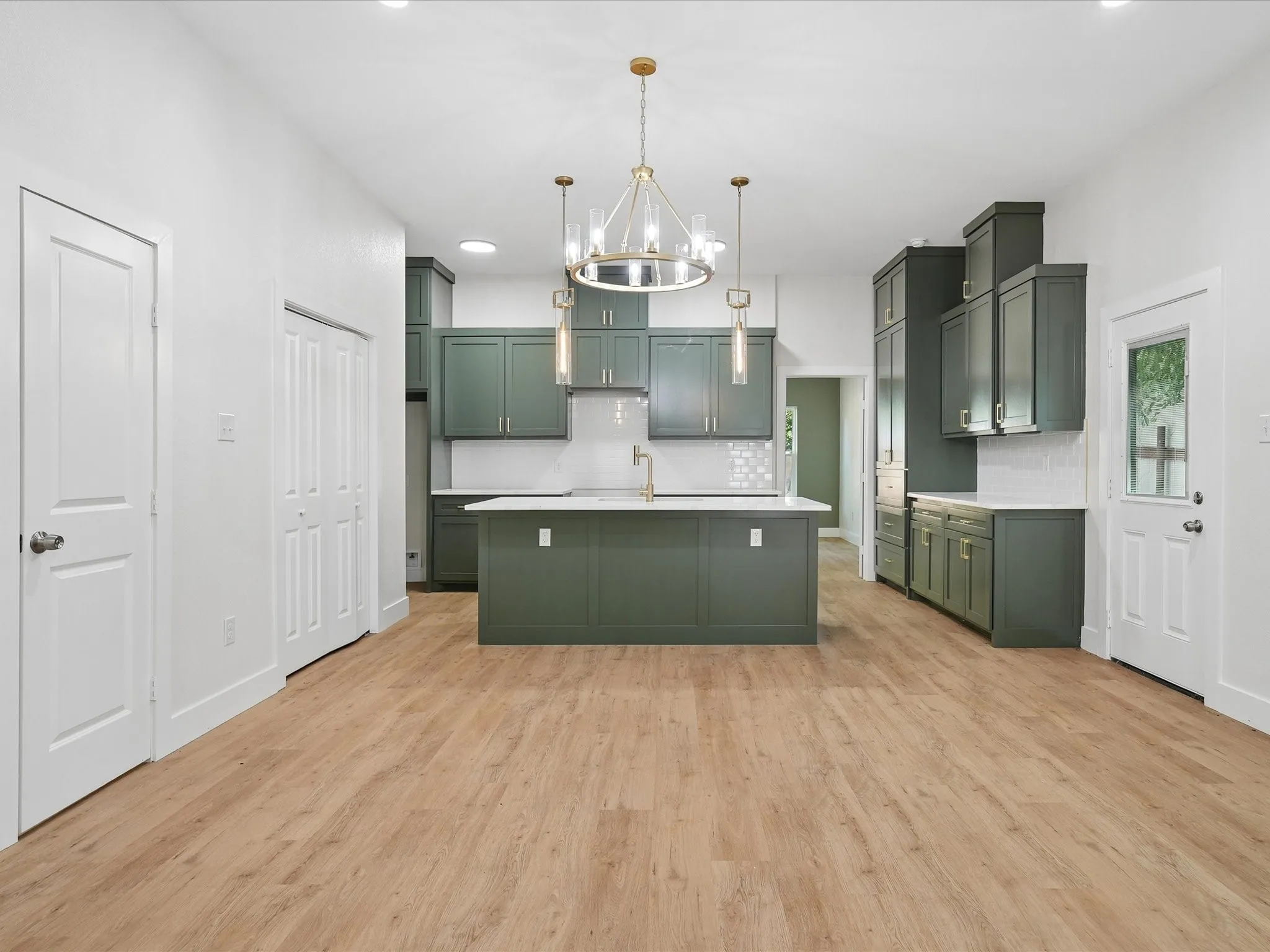 Open-concept kitchen featuring an island, recessed lighting, wood-finish flooring, and pendant lighting