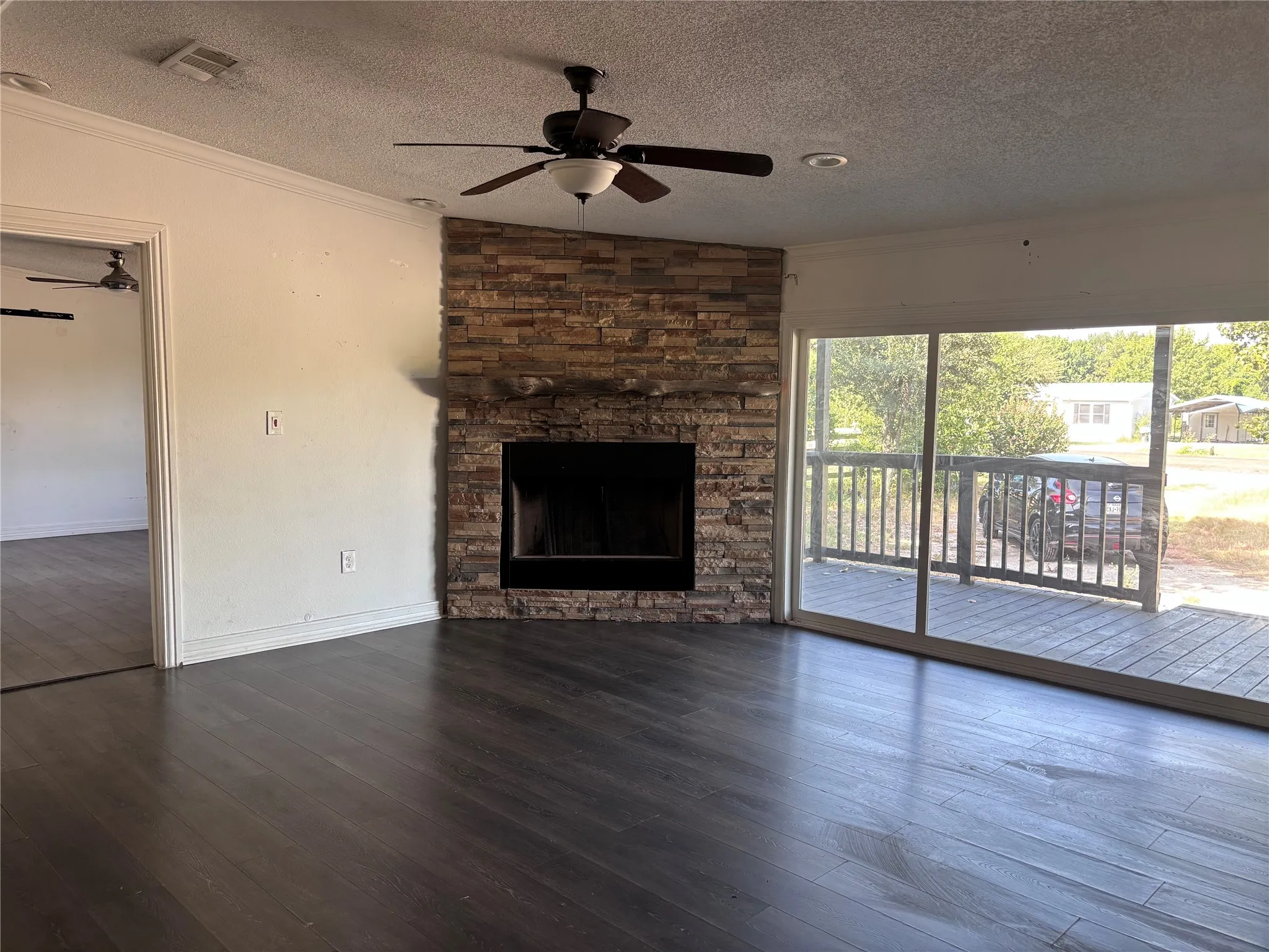 Stacked stone fireplace with a wood mantel