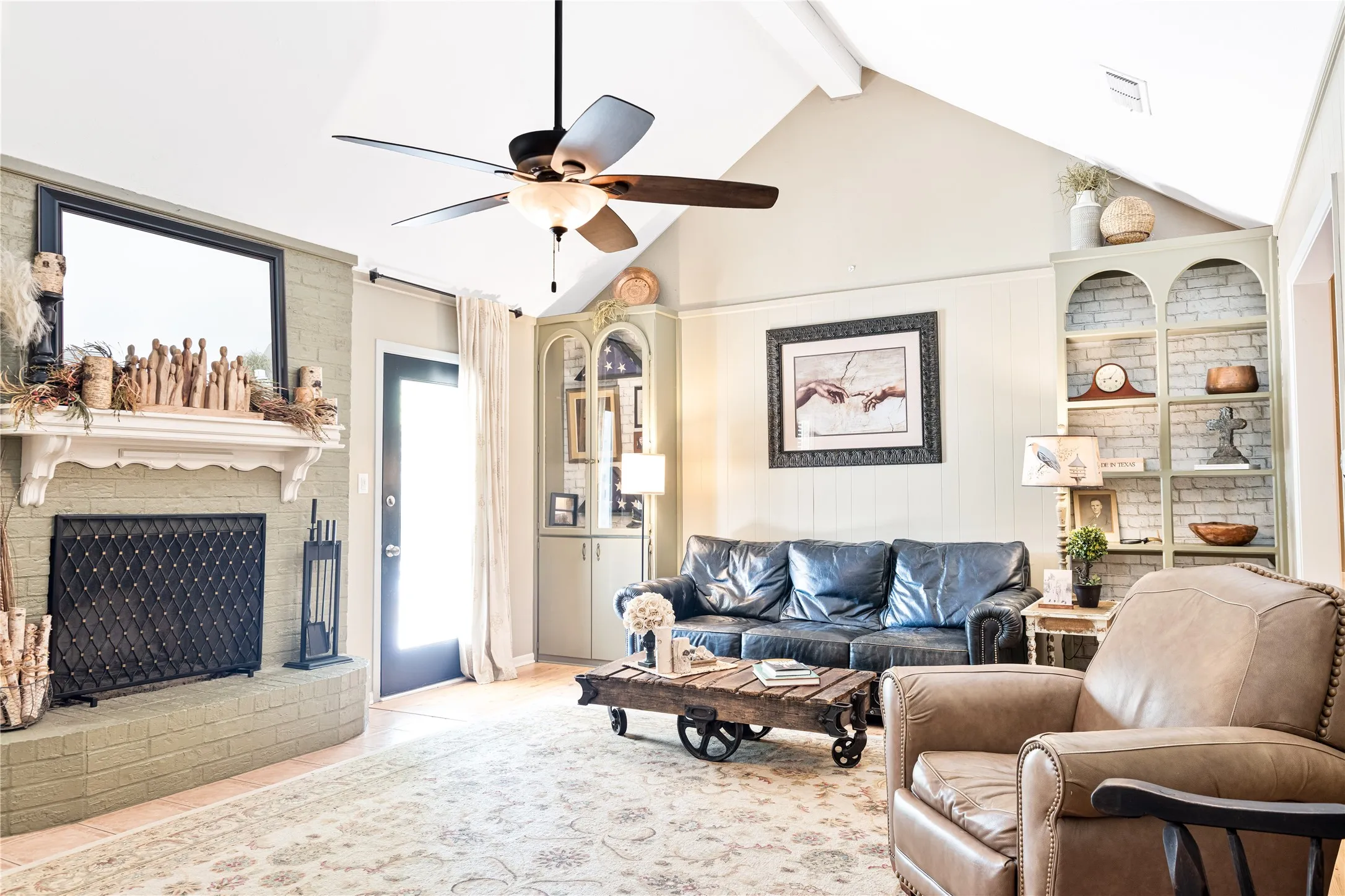 Vaulted ceiling with exposed beams and a ceiling fan