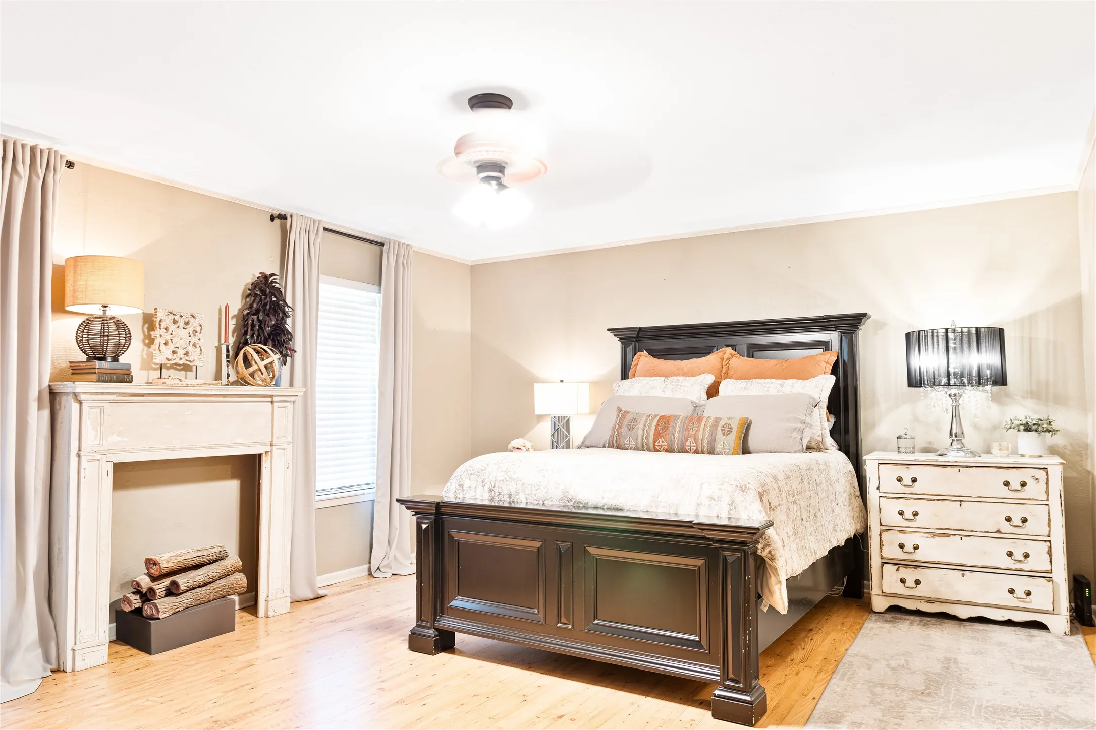 Light-toned wood-finish flooring with a ceiling fan overhead
