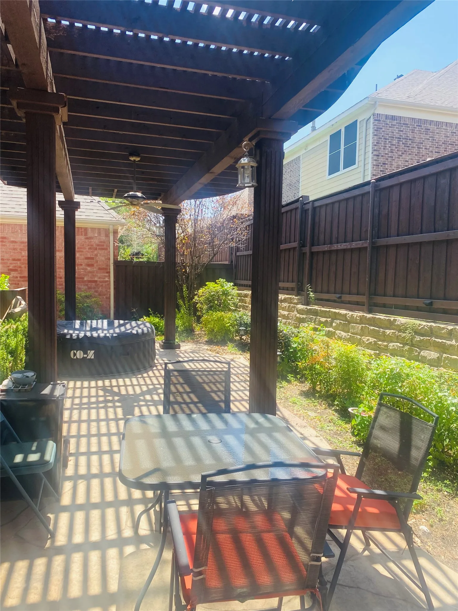 Outdoor pergola featuring a ceiling fan, recessed lighting, and a paved patio area