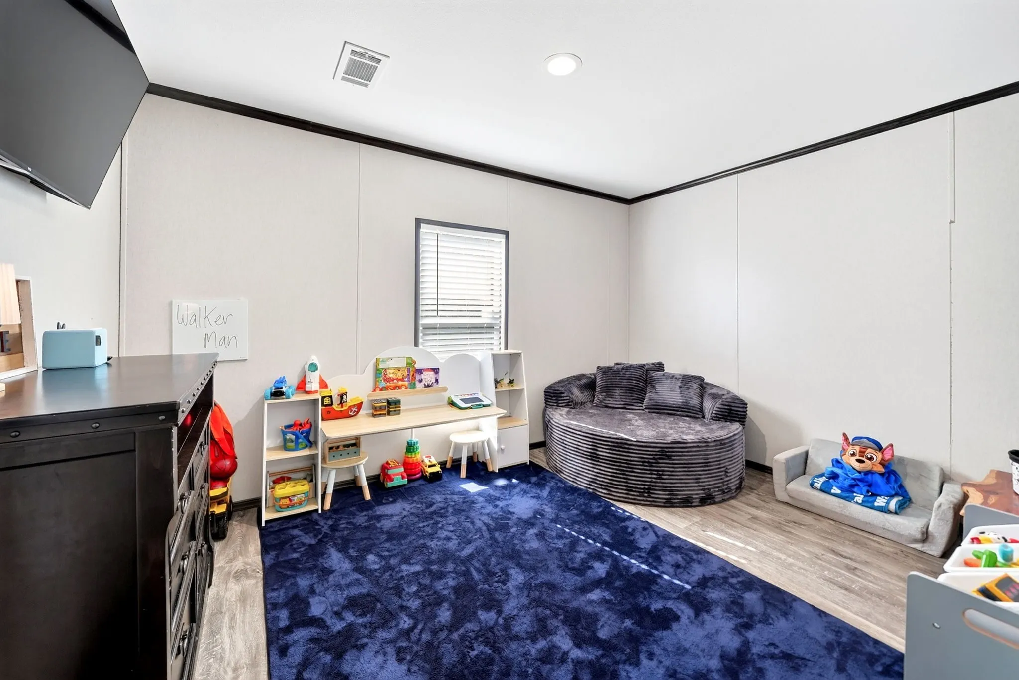 Recessed lighting, wood-finish flooring, and a window with blinds