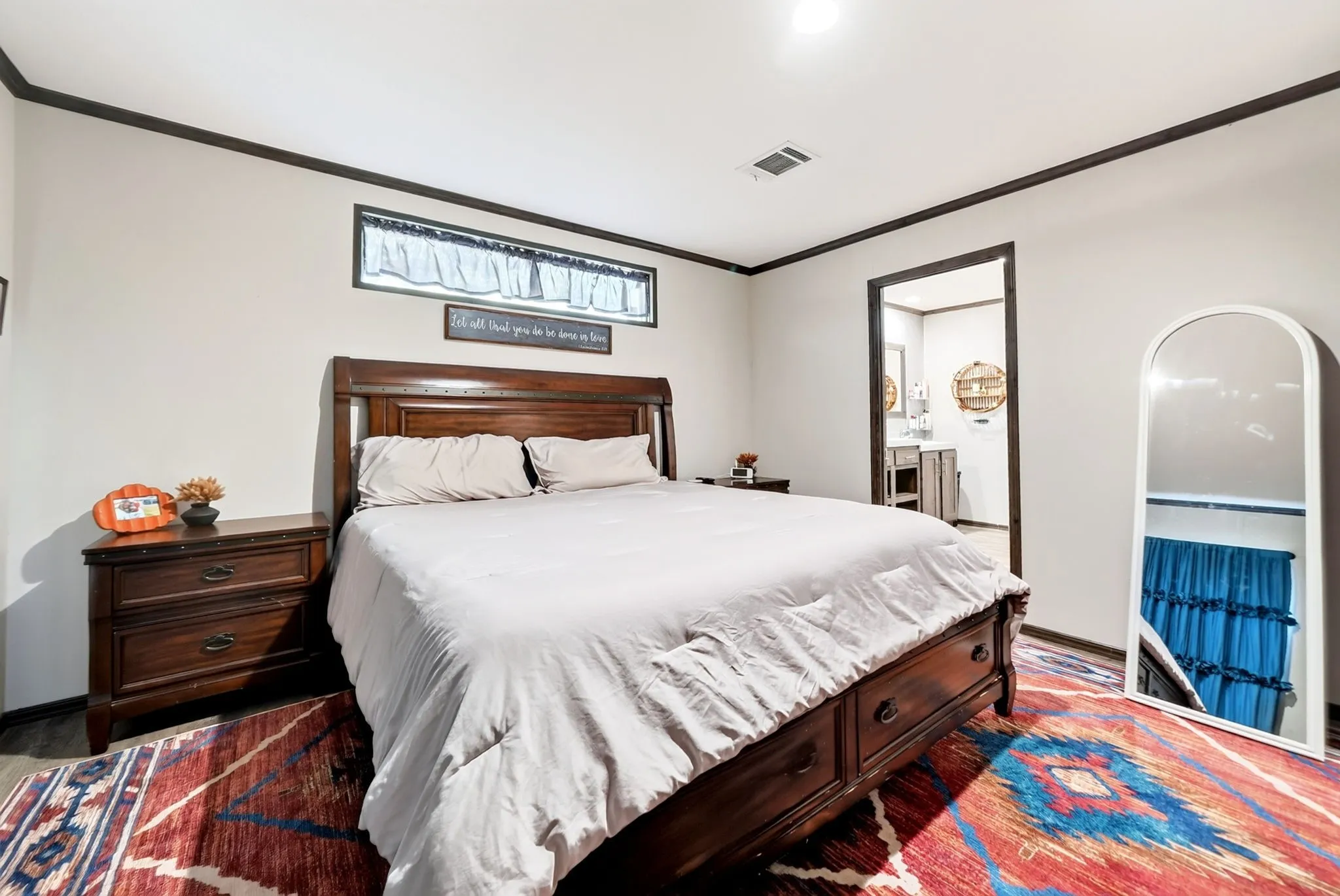 Wood-finish flooring with a contrasting baseboard trim and crown molding