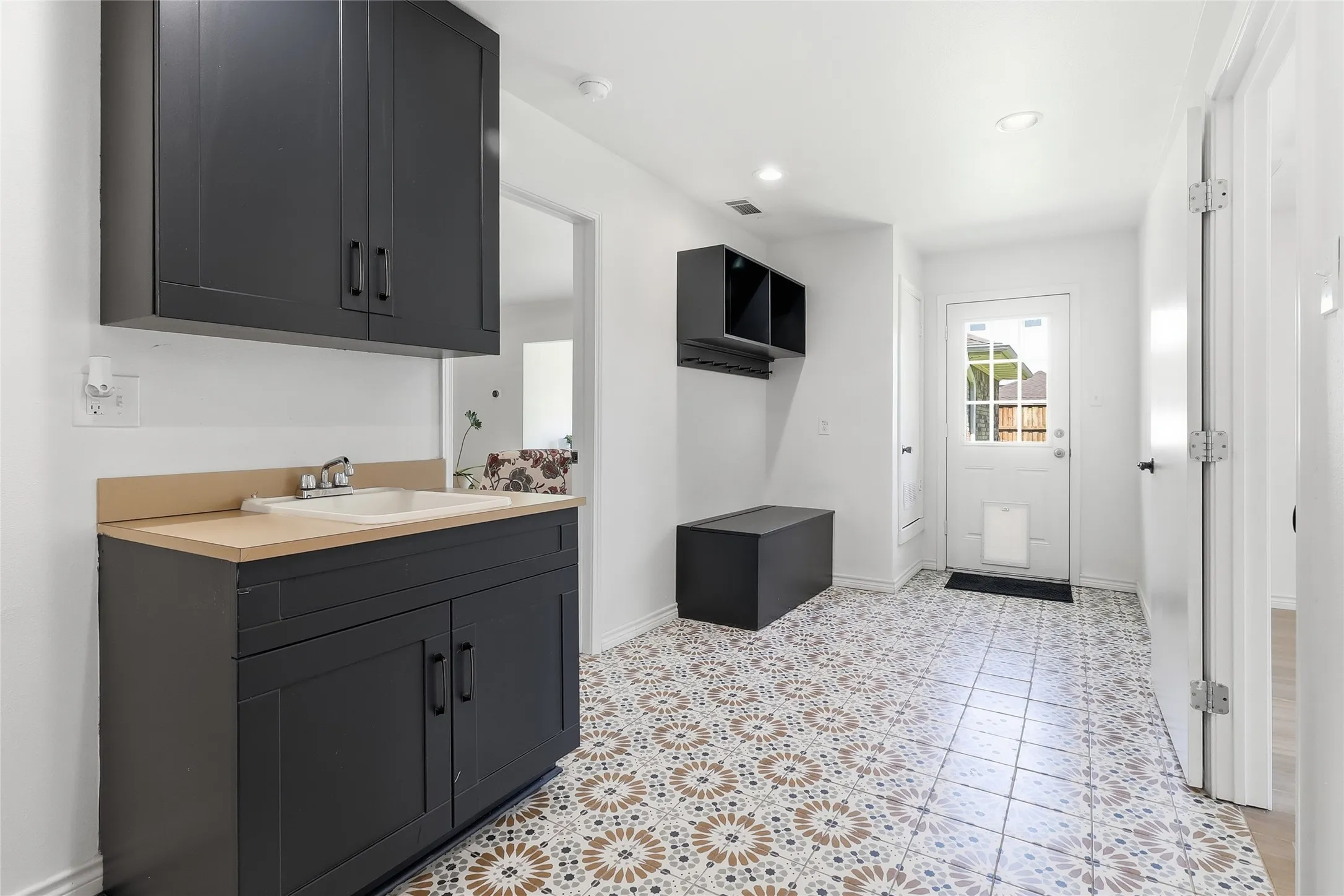 Large laundry/mud room including doggie door leading to the backyard.