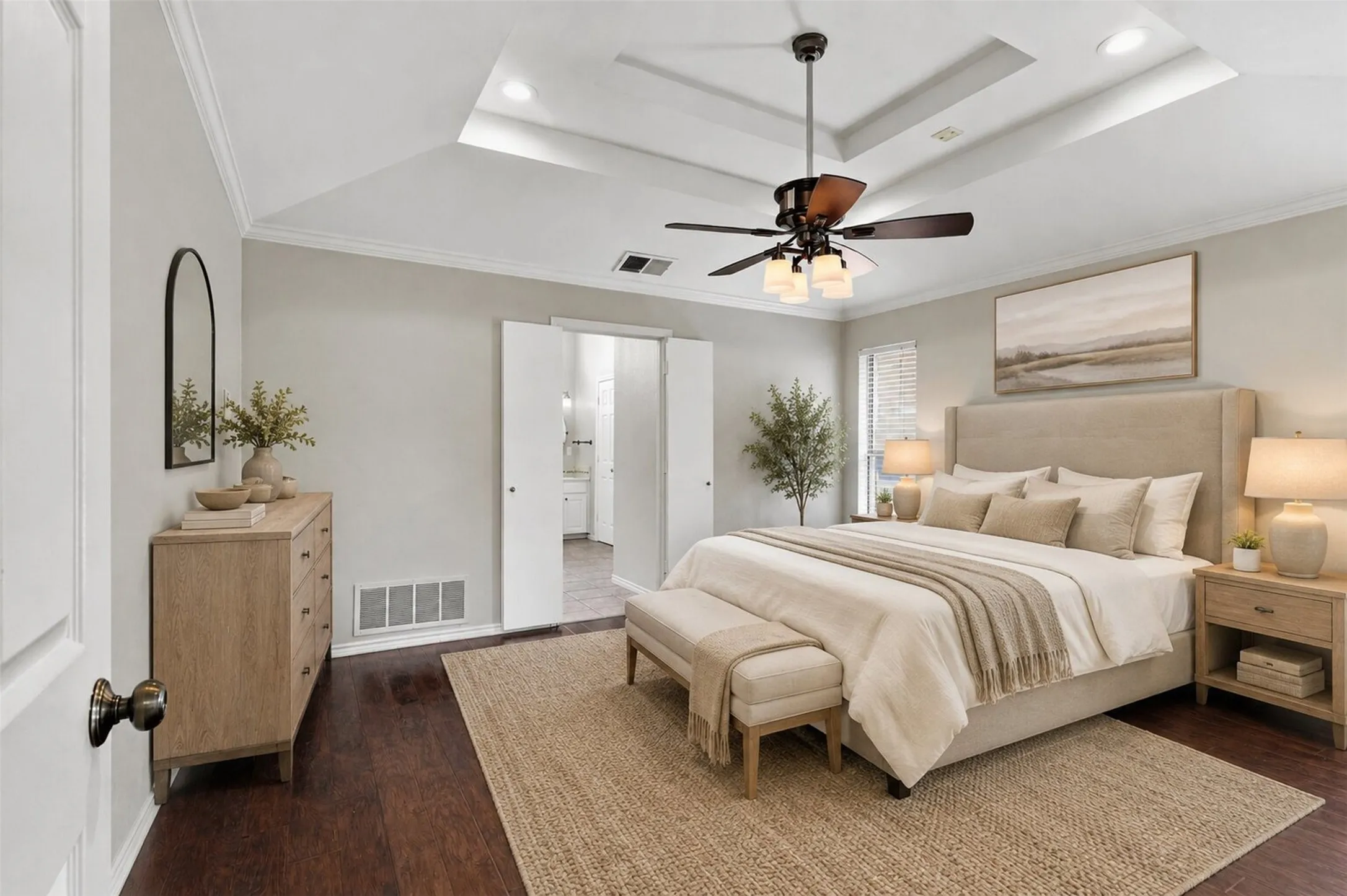 Tray ceiling with a ceiling fan, crown molding, and dark wood-finish flooring