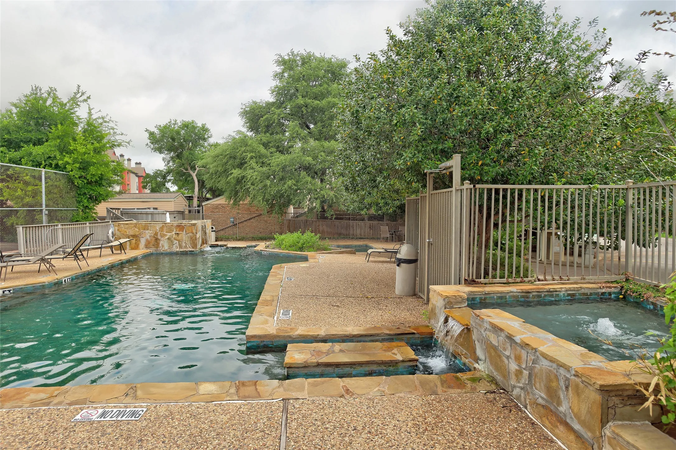 Resort-style backyard oasis featuring a sparkling swimming pool with stone coping, and sun deck