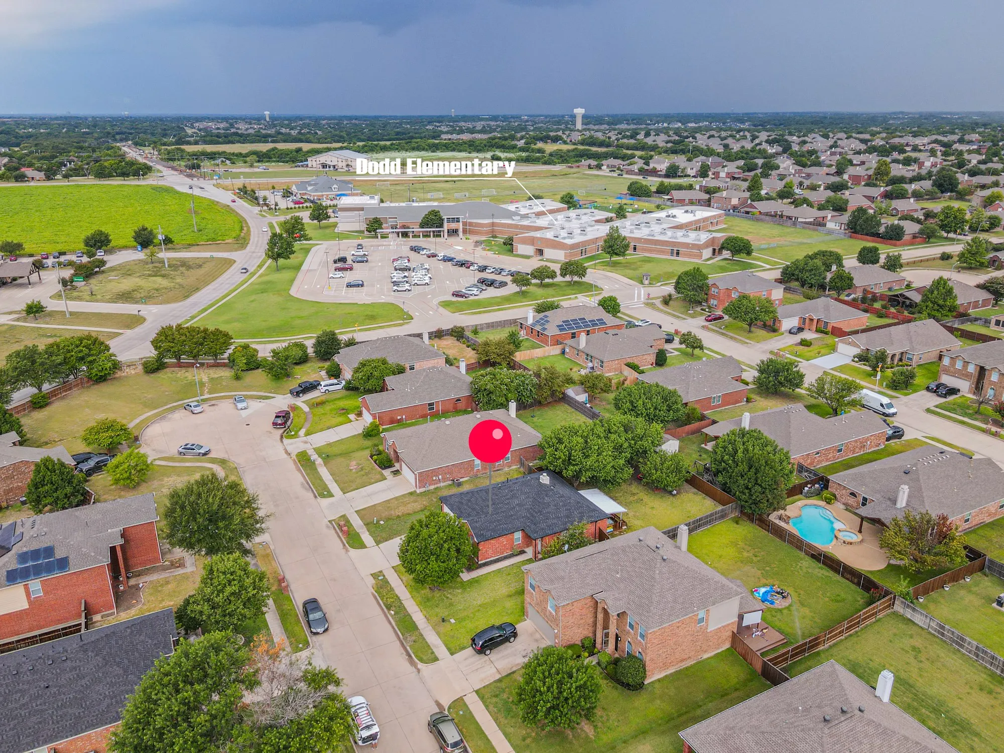 Residential area featuring single-family homes with brick exteriors and shingle roofs