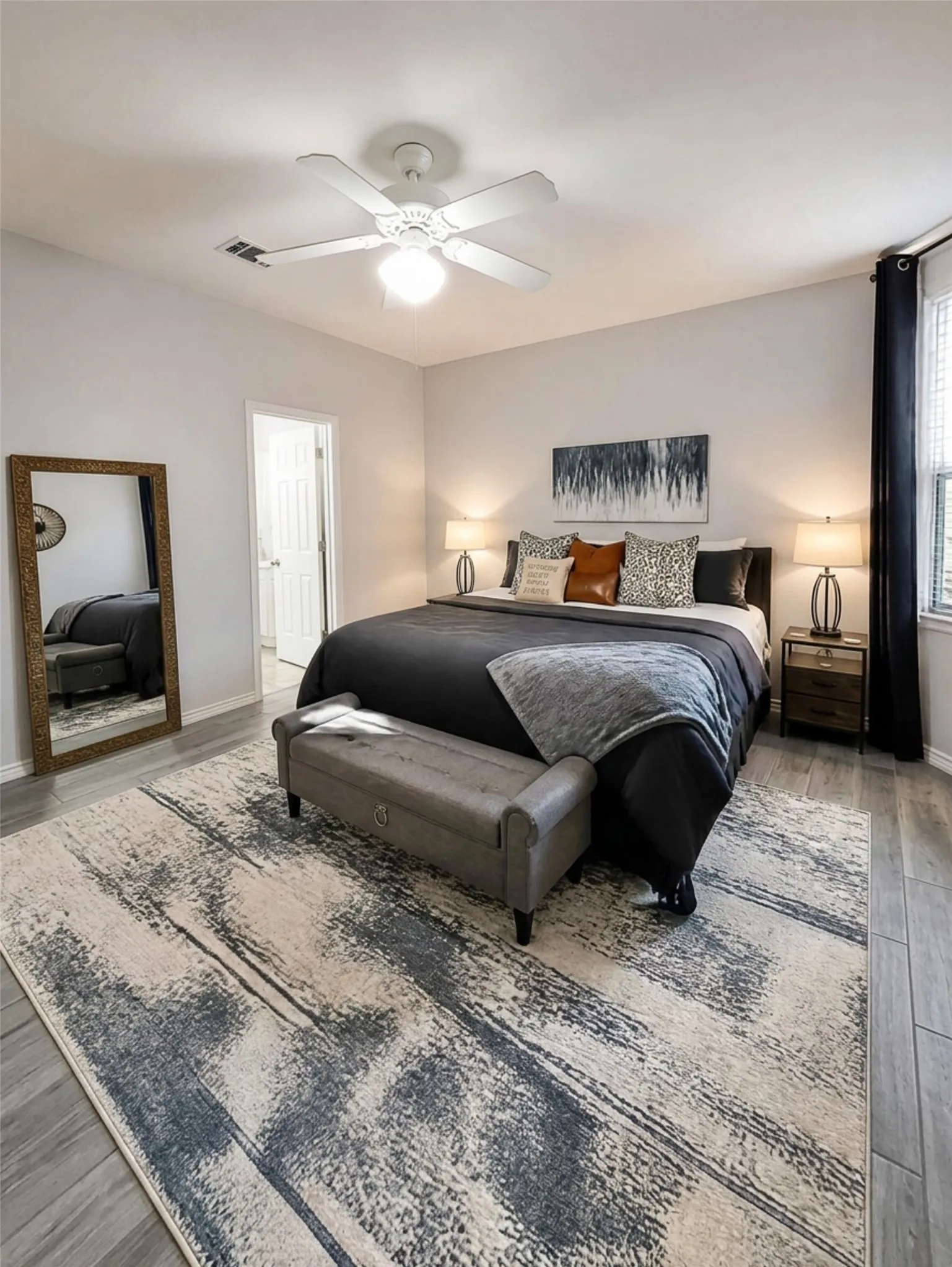 Wood-finish flooring, ceiling fan with integrated lighting, and neutral wall tones