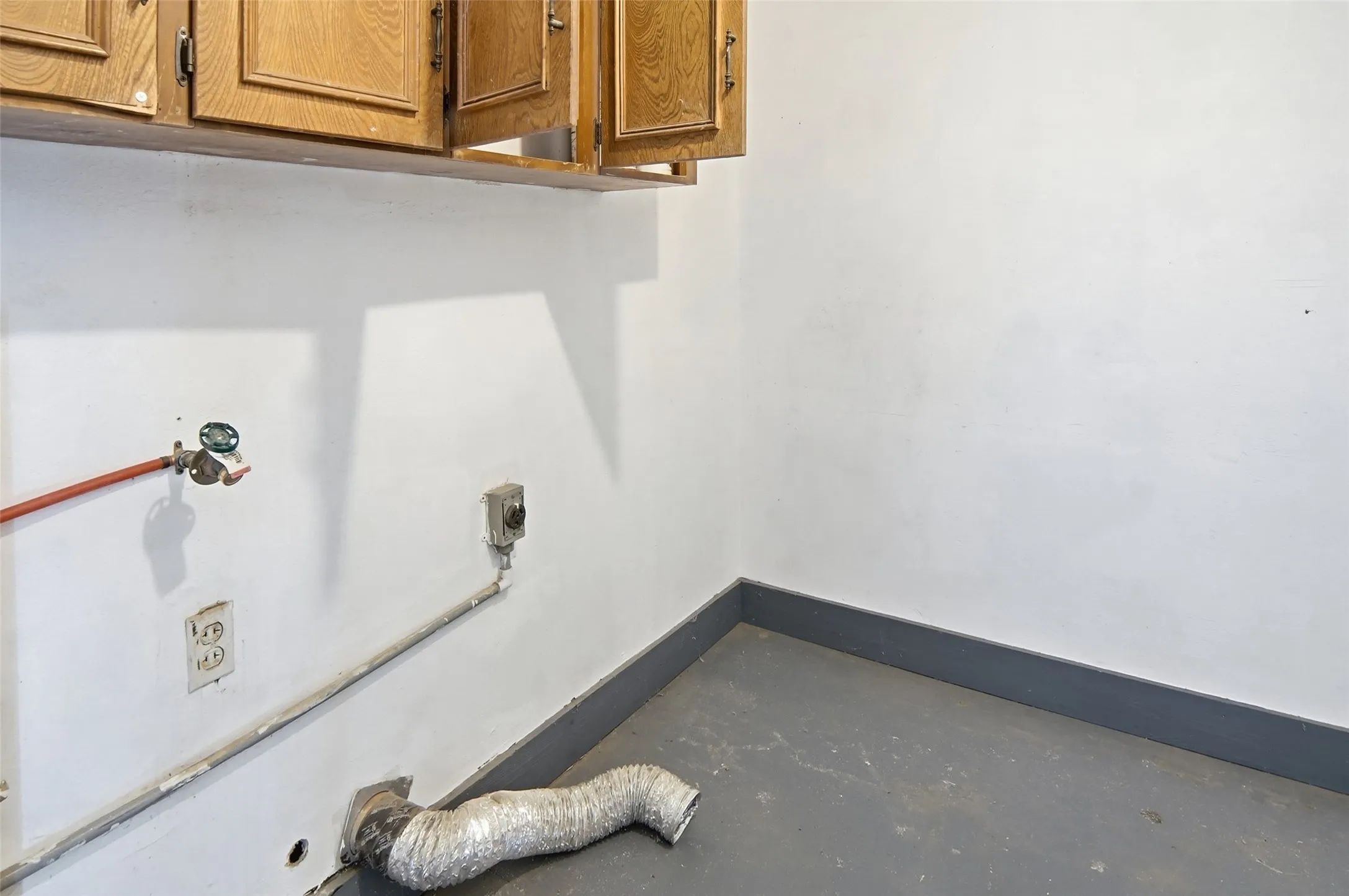 separate utility room with cabinets.