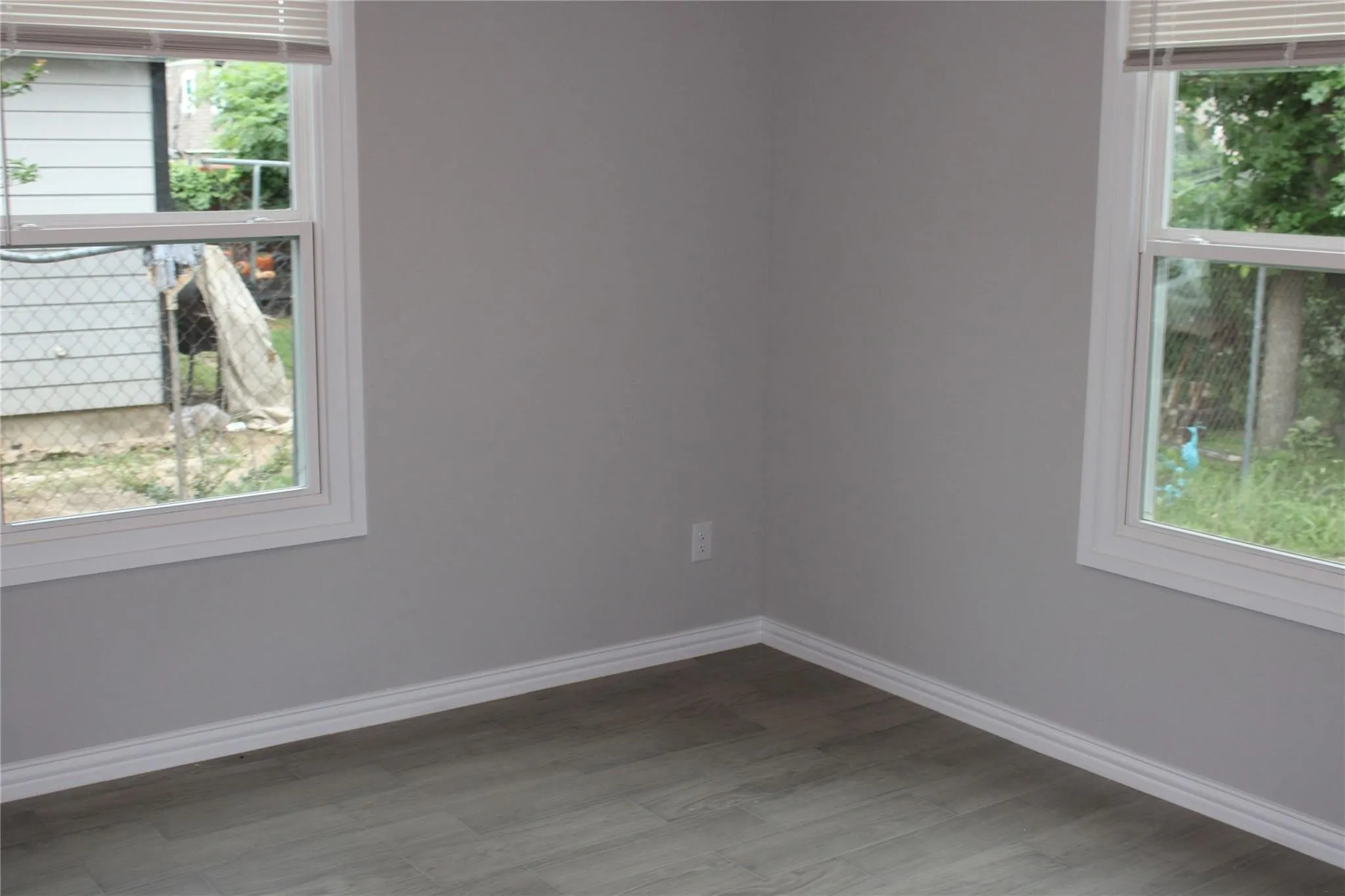 Neutral wall color, wood-finish flooring, and white trim