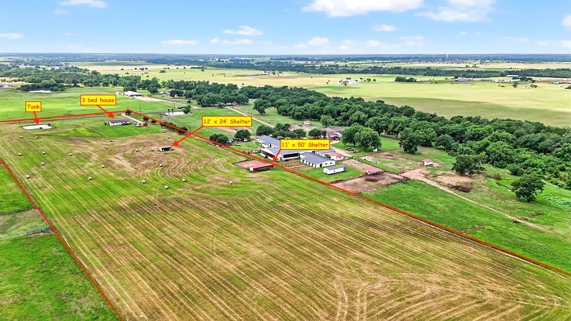 Expansive rural property featuring multiple structures, open fields, and mature​​‌​​​​‌​​‌‌​‌‌​​​‌‌​‌​‌​‌​​​‌​​ trees
