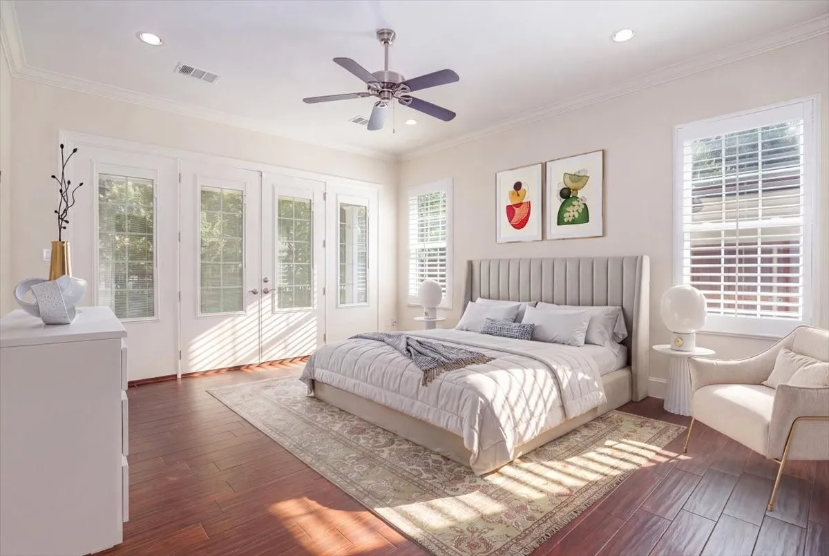 Porcelain wood-finish flooring, recessed lighting, crown molding, double French doors, and a ceiling fan